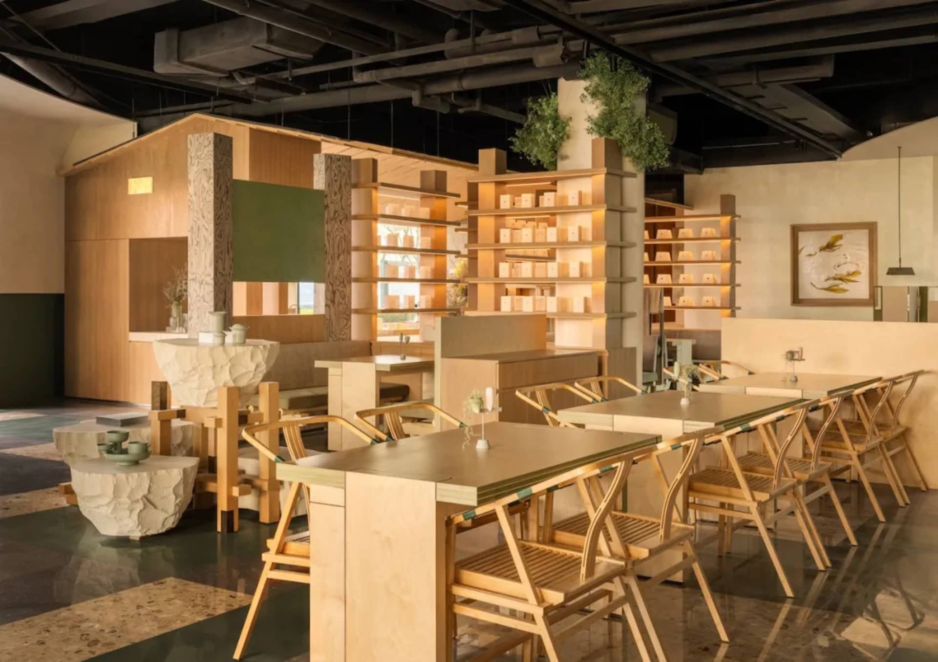 A modern restaurant interior with multiple tables, chairs, and potted plants, well-lit and welcoming