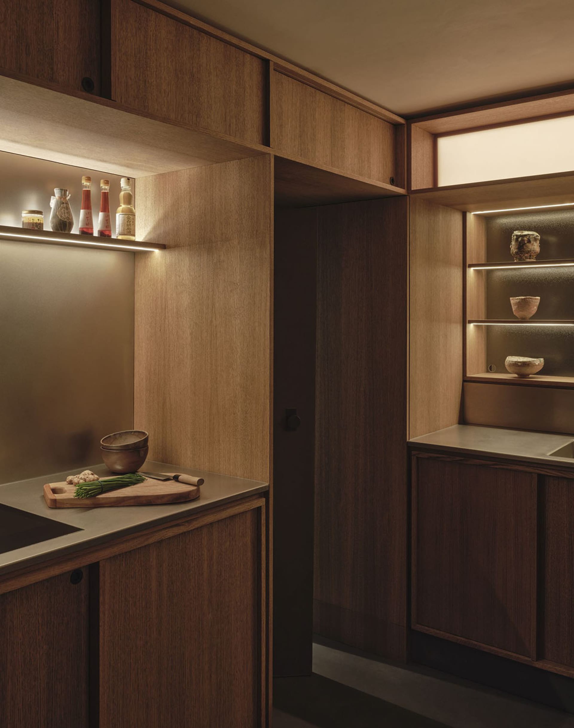 Warm and inviting kitchen with wooden cabinets, a countertop, and dim lighting