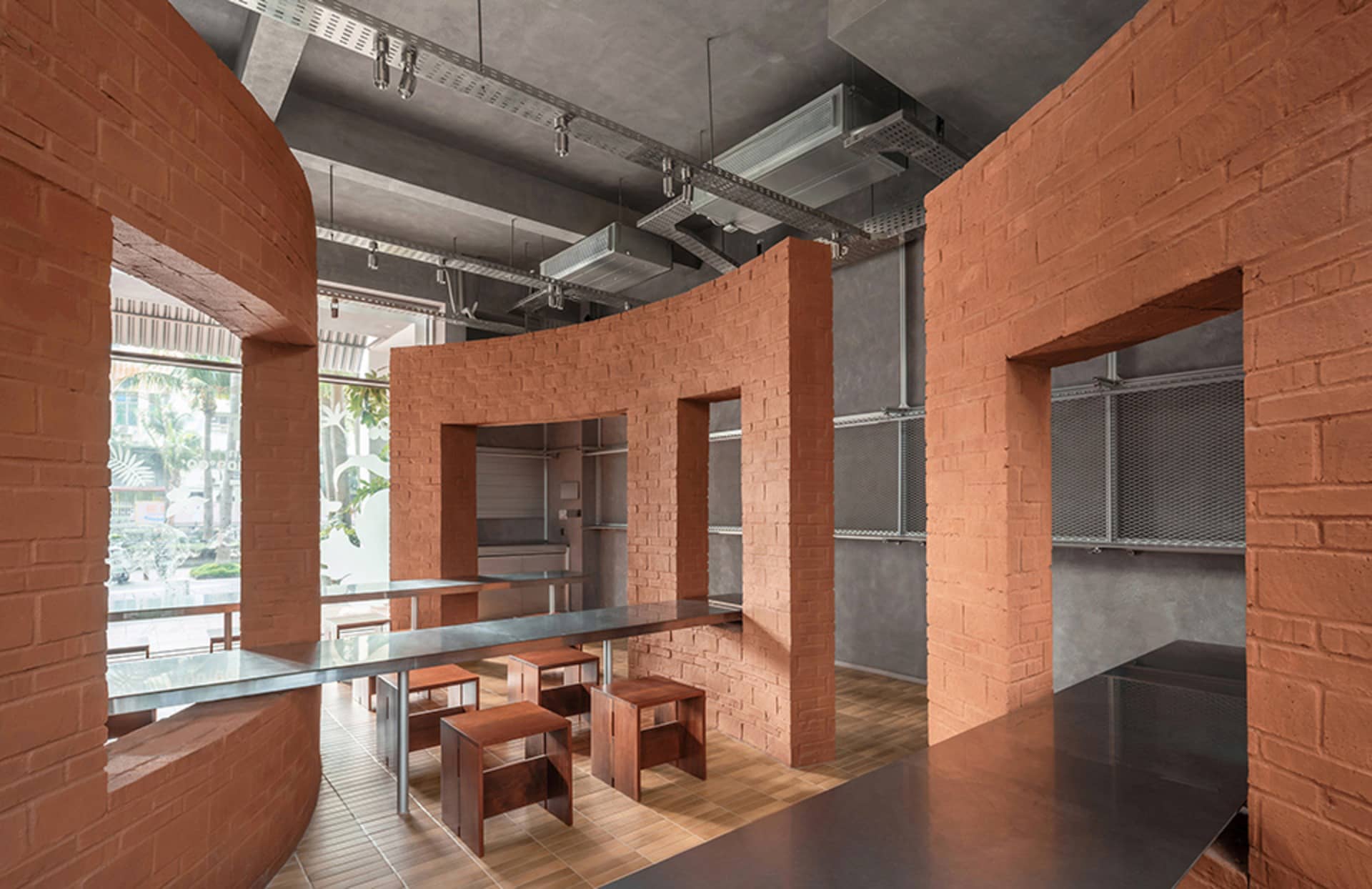 A warm and inviting restaurant dining area with a brick wall, wooden chairs, and a dining table, set in a soft and diffused lighting environment