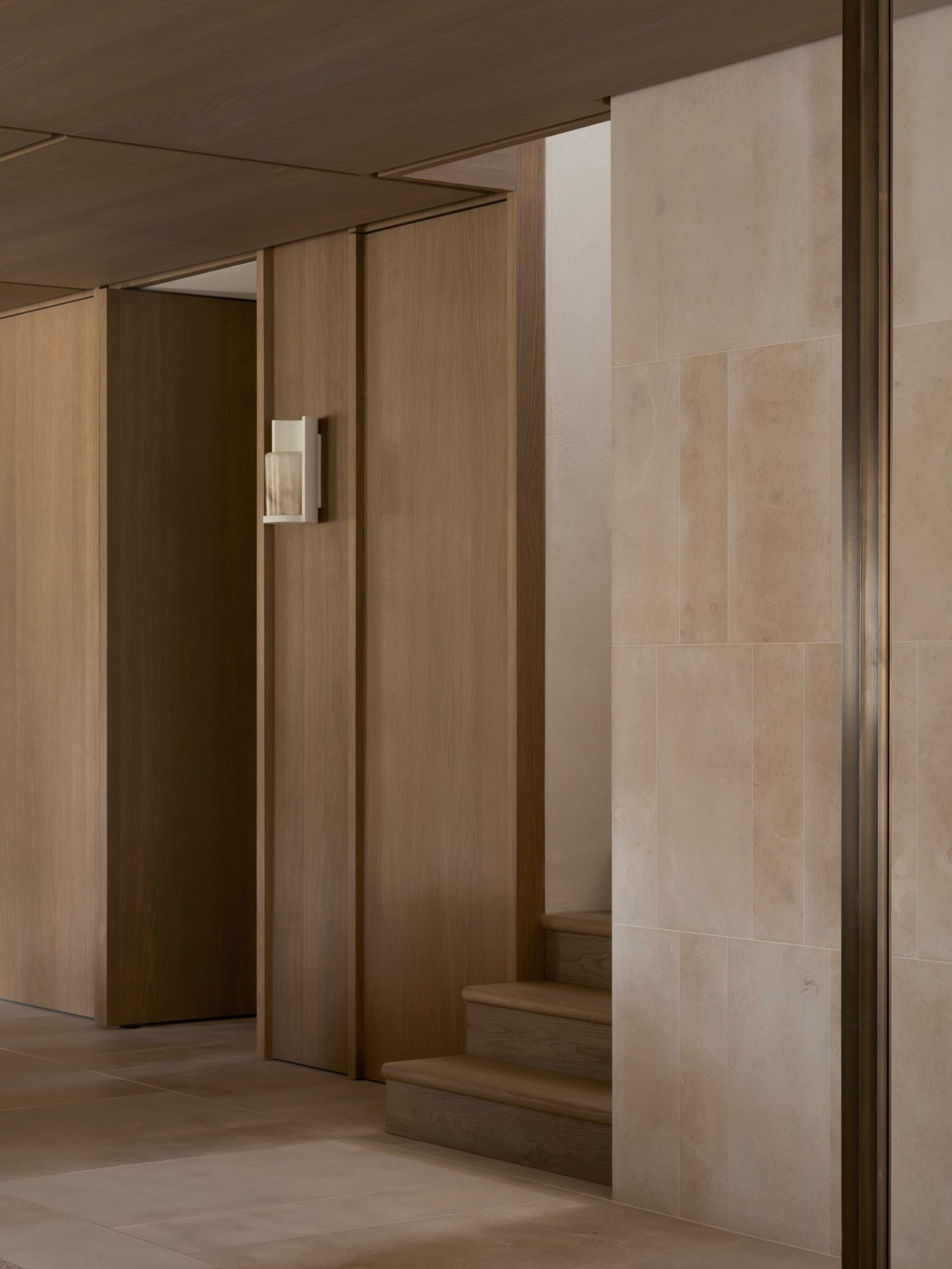 A dark and gloomy hallway with wooden walls, lined with doors and a light on the wall