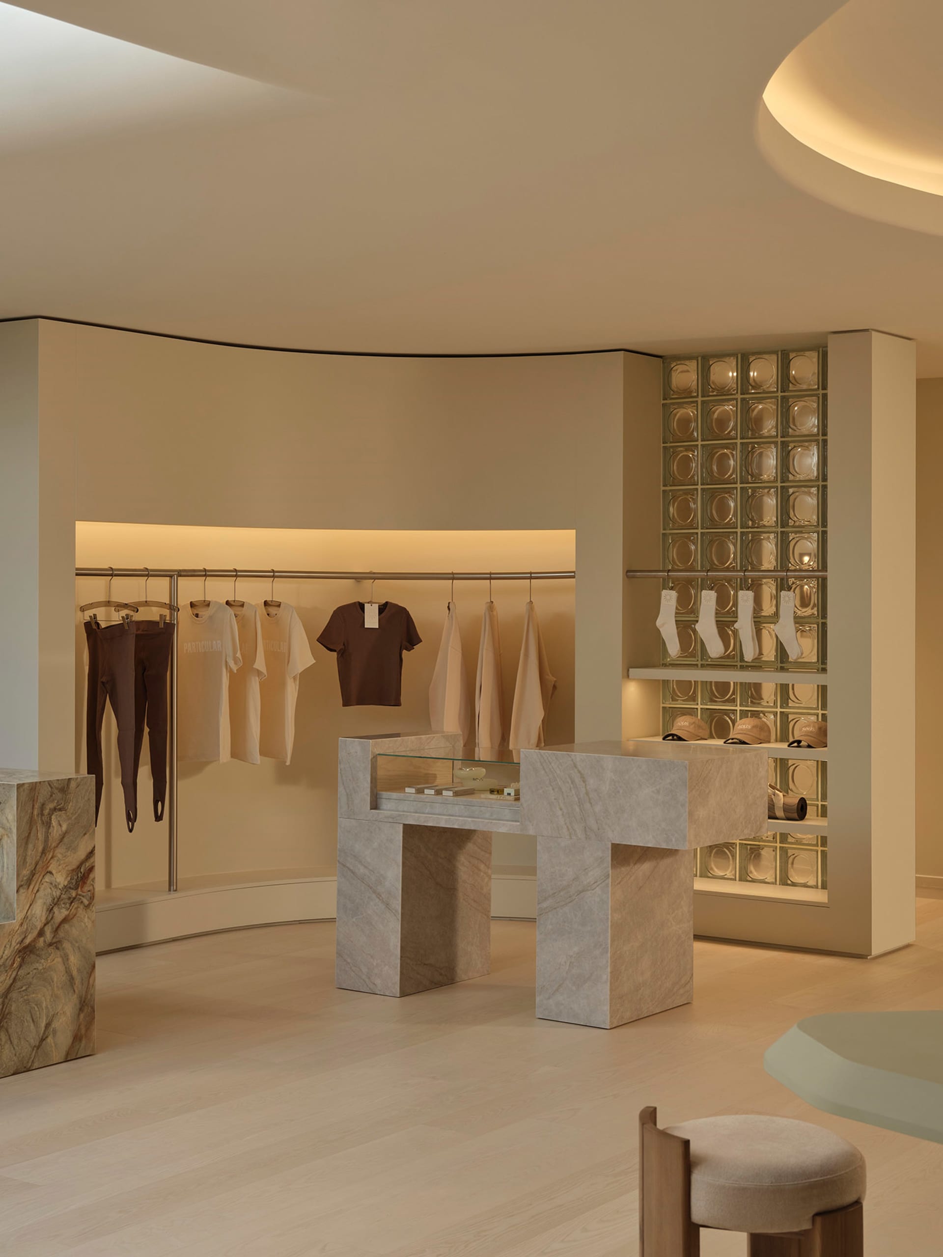 A well-lit clothing store with neatly arranged racks of shirts and pants, creating an inviting and organized shopping environment
