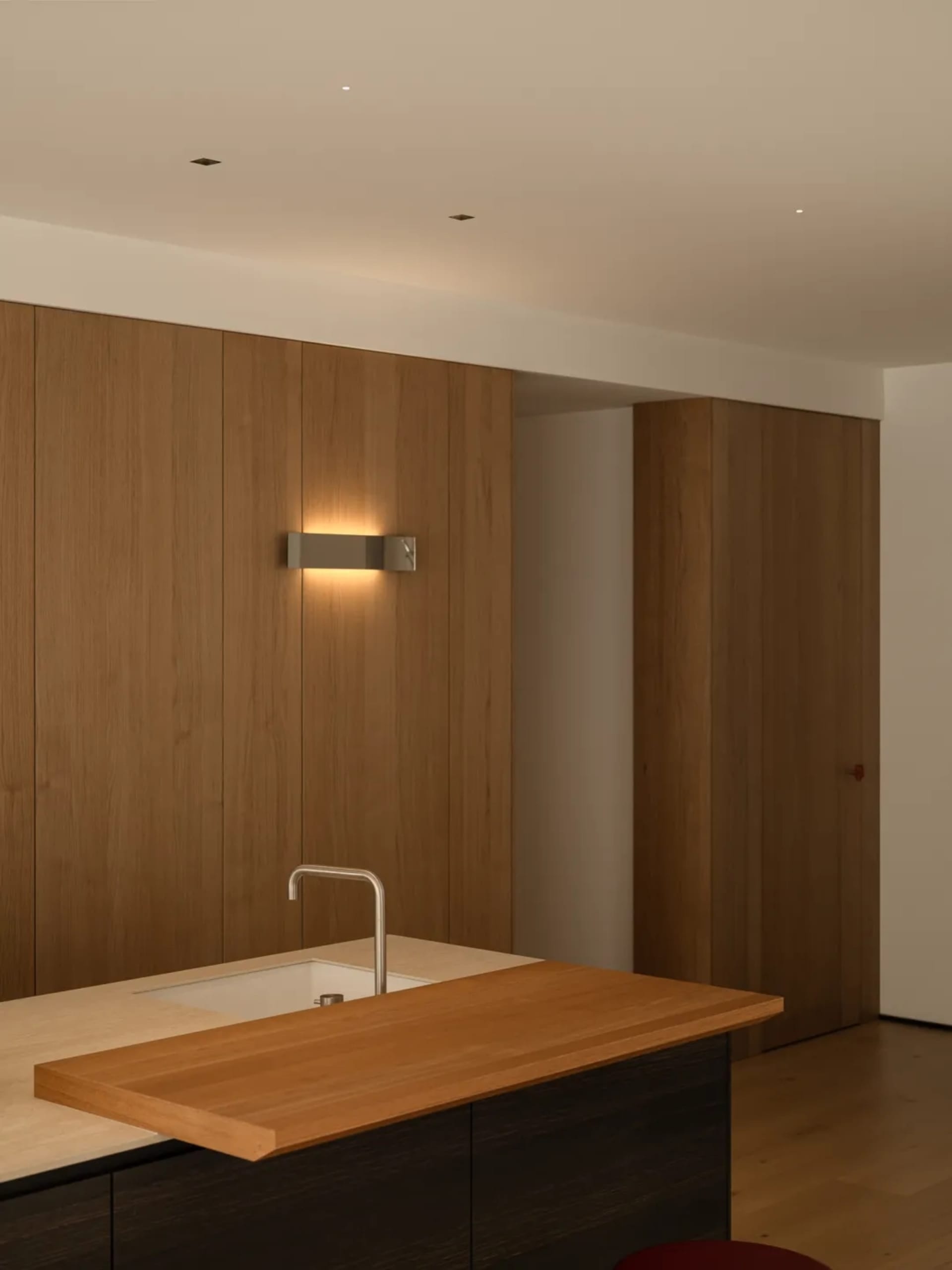 Bathroom with a wooden sink and walls, dim lighting creating a cozy atmosphere