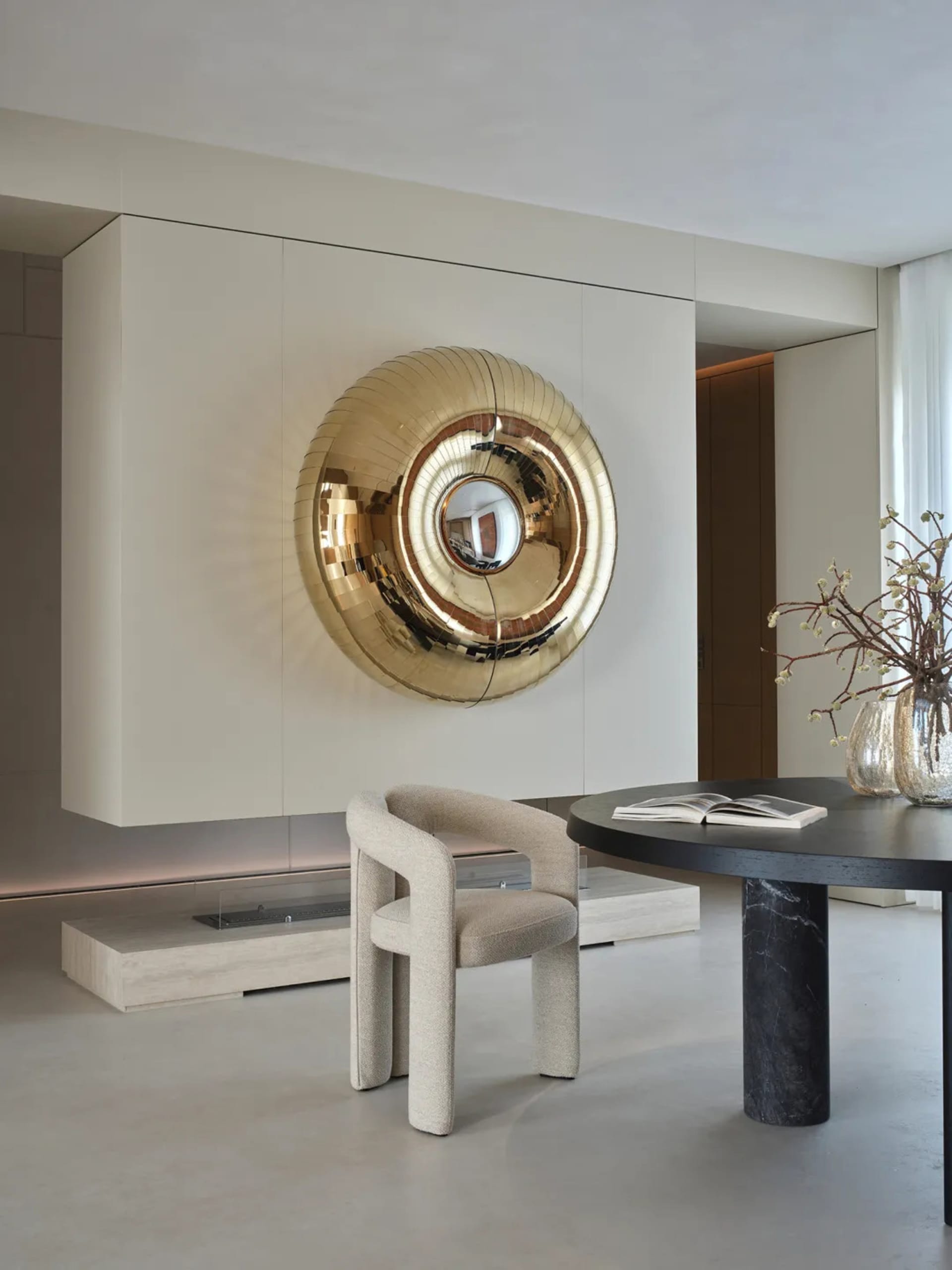 A modern living room with a fireplace, neutral colors, and natural light from windows