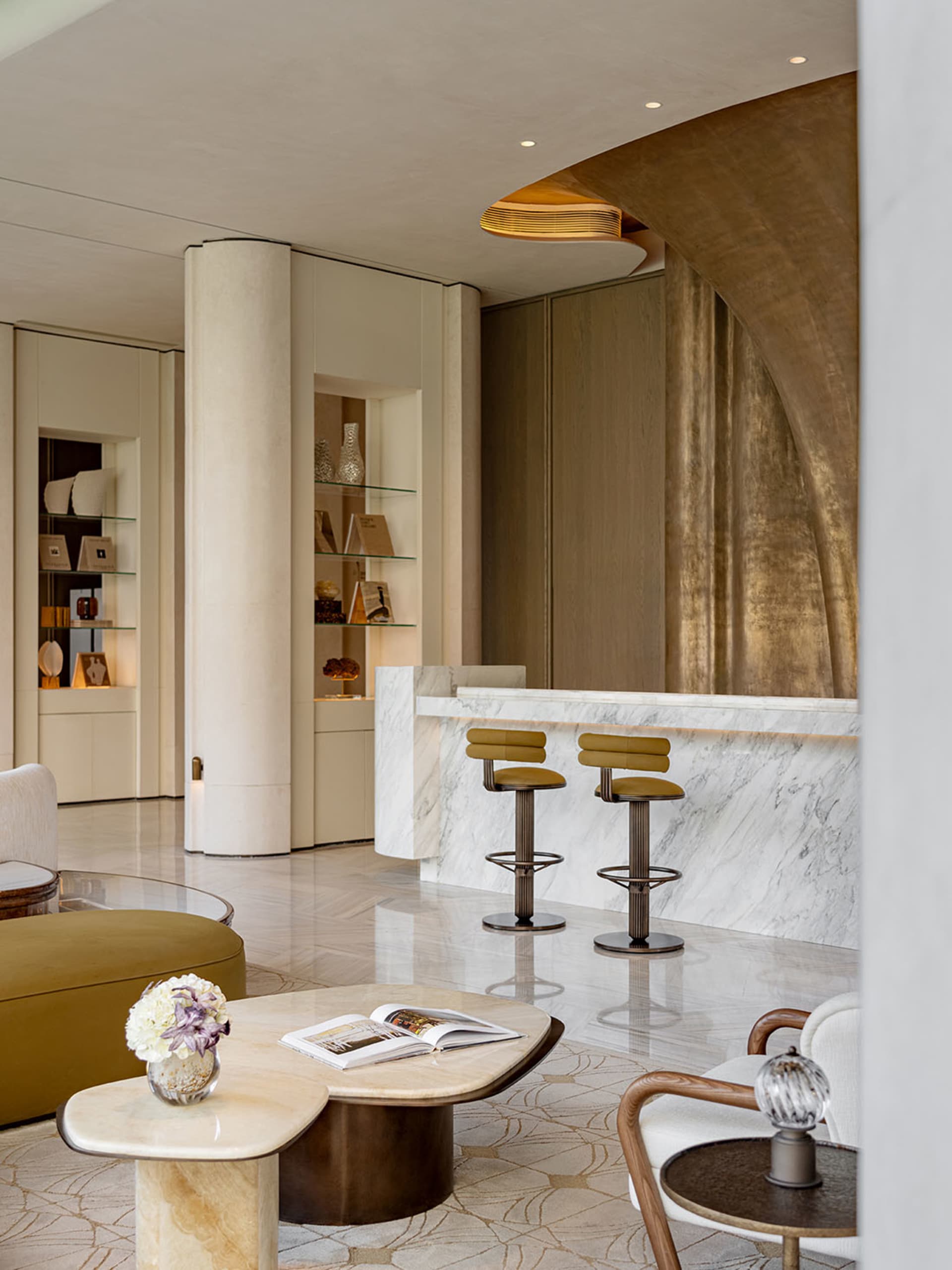 Comfortable living space with a white couch, dining table, bar area, and natural light from a large window