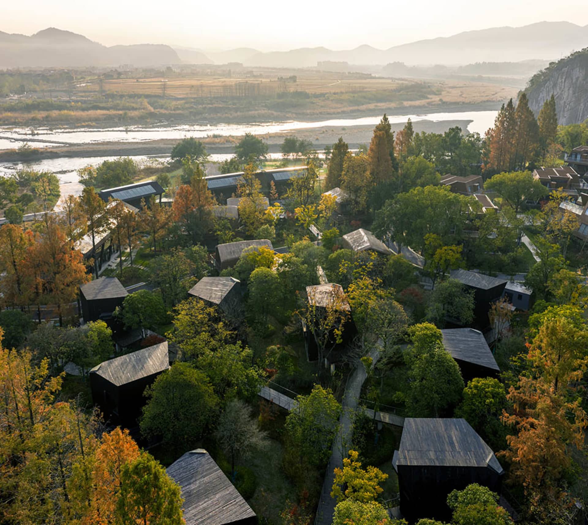 A picturesque village with wooden houses, situated near a river, creating a peaceful and serene atmosphere