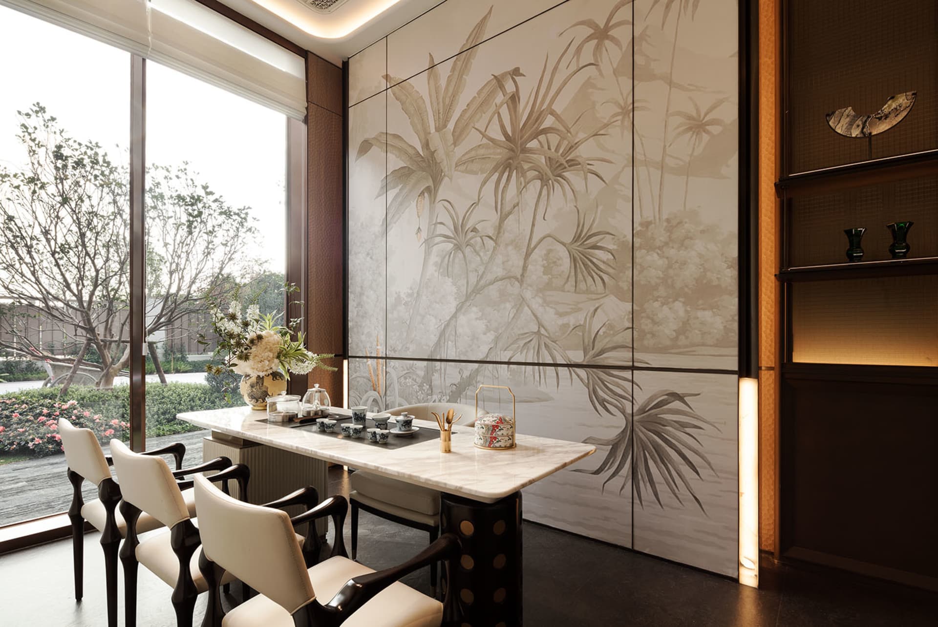 A modern dining room with a wooden dining table and chairs, surrounded by a large window with natural light, creating a bright and inviting atmosphere