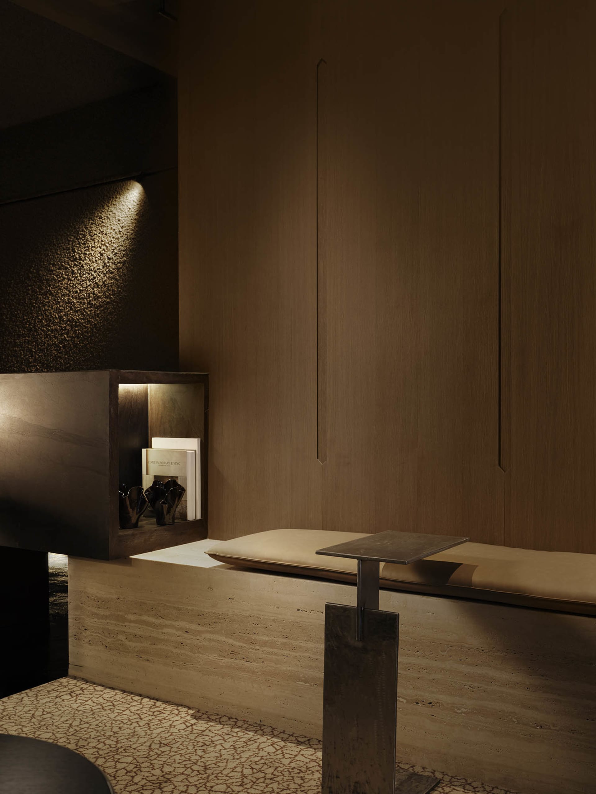 Cozy dining area with a wooden table and bench in a modern space with dim lighting
