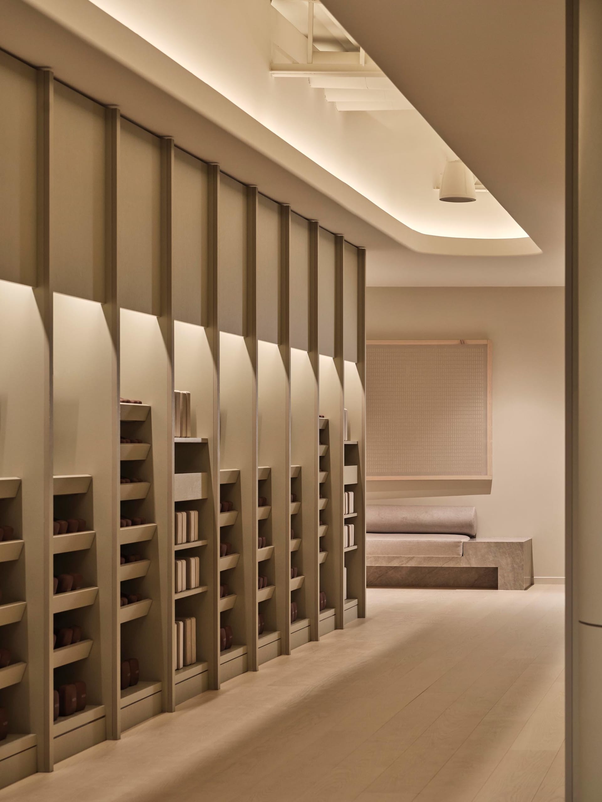 A study area with a large wooden bookshelf filled with books, creating a cozy and intellectual atmosphere