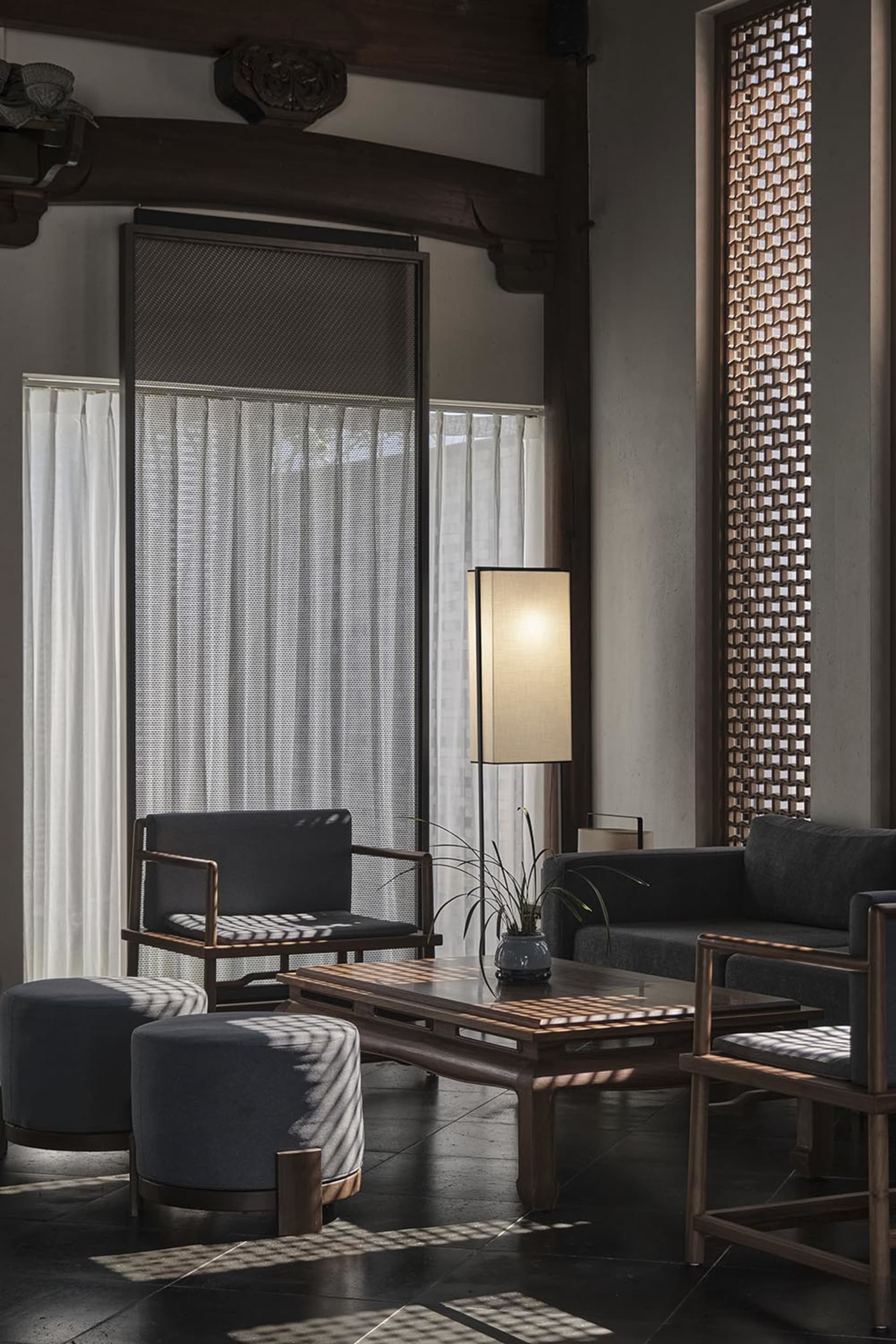 Cozy living room with a couch, chair, and table on a hardwood floor, soft and diffused lighting, and neutral colors