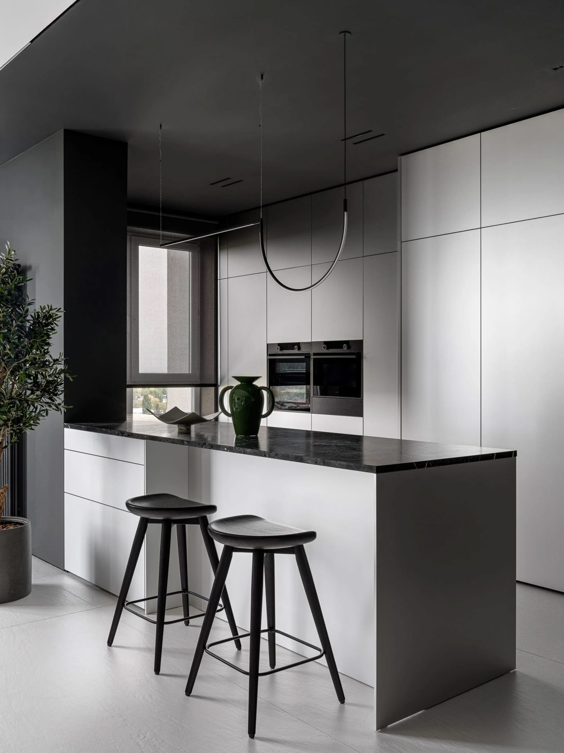 Sleek modern kitchen with a large island, natural light, and a clean design