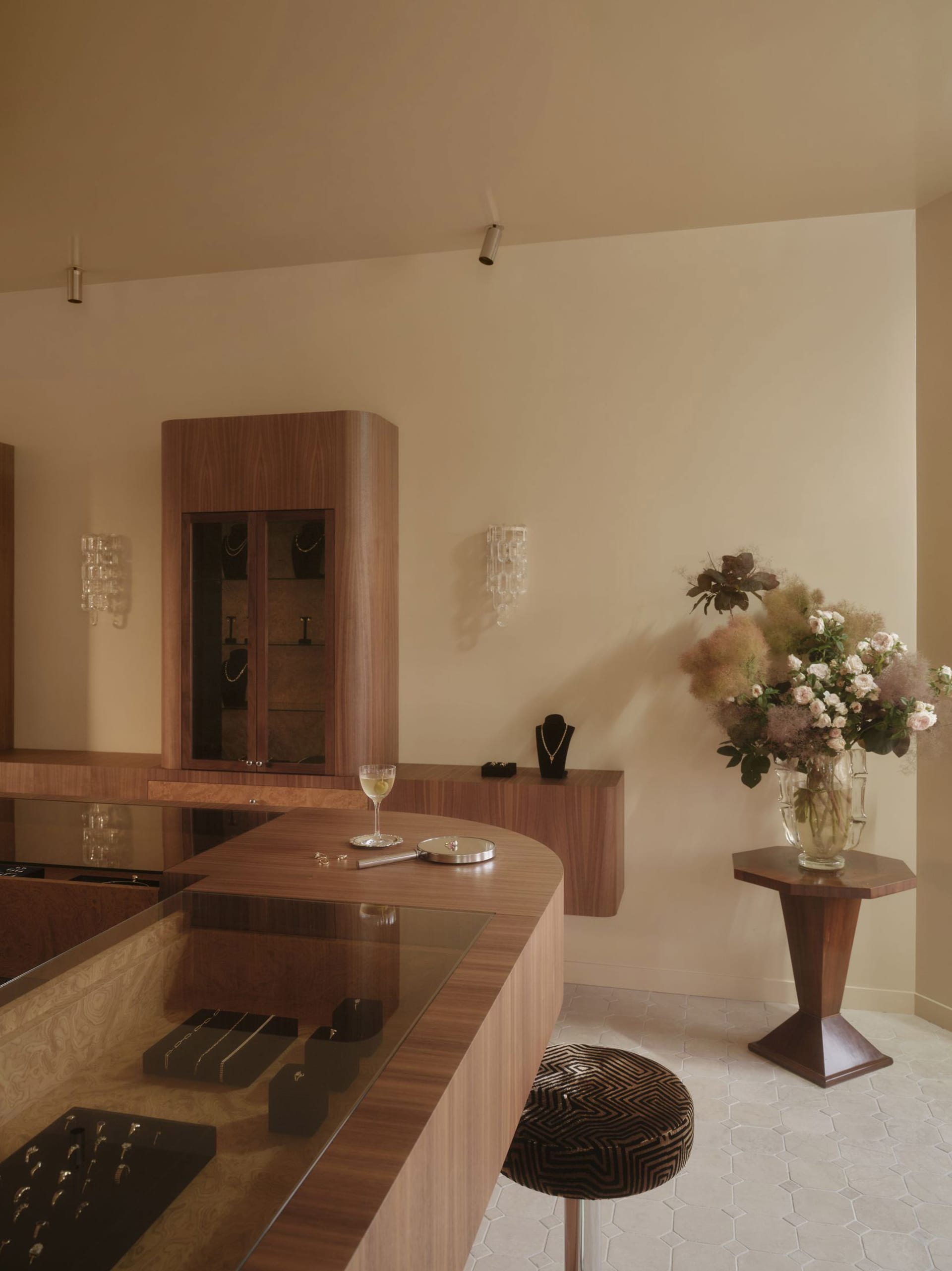 A dimly lit kitchen with a wooden countertop, a wooden cabinet, and a vase, creating a warm and inviting atmosphere
