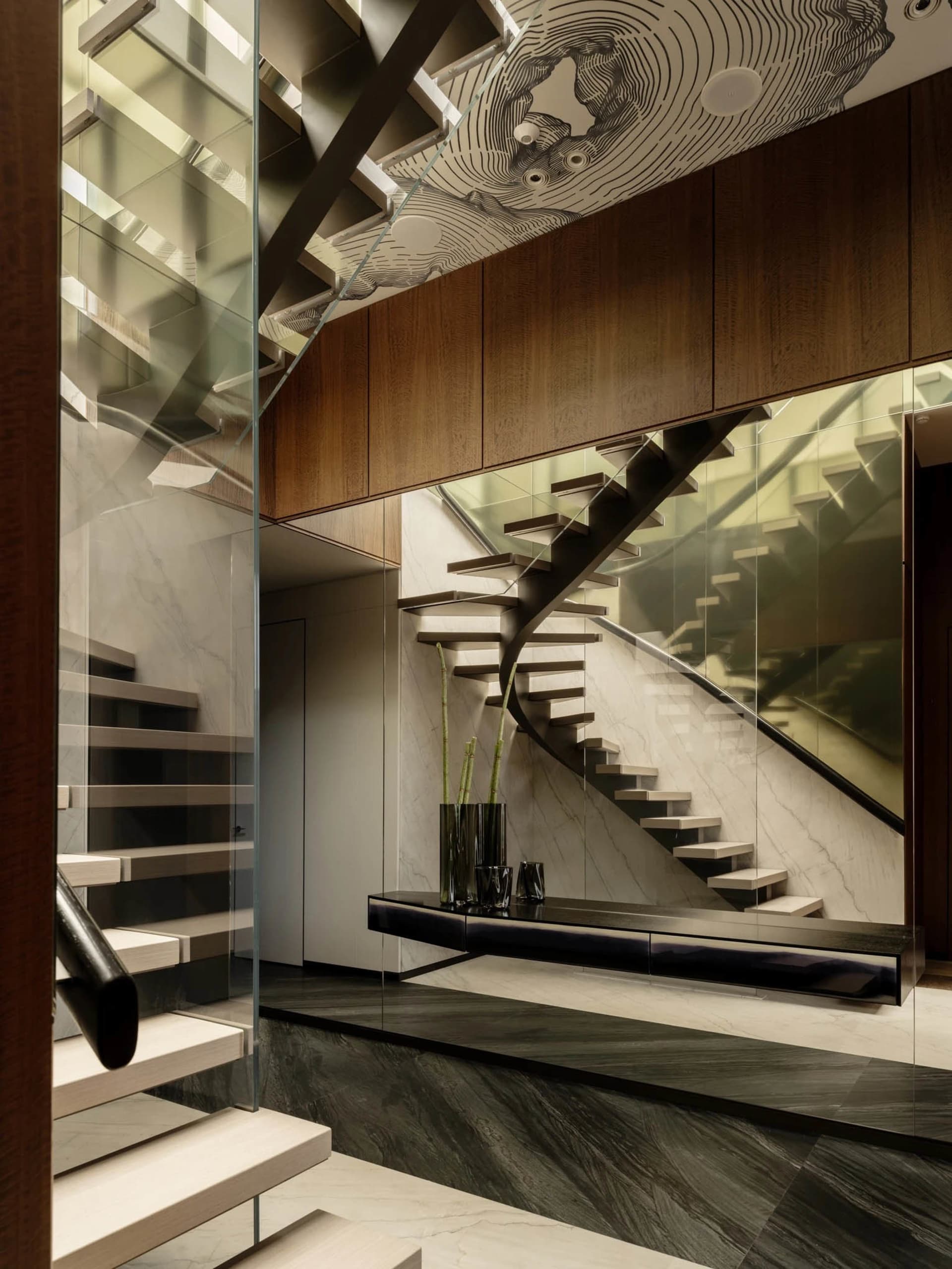 A modern building hallway with a spiral staircase made of wood and glass railing, a bench, and bright lighting