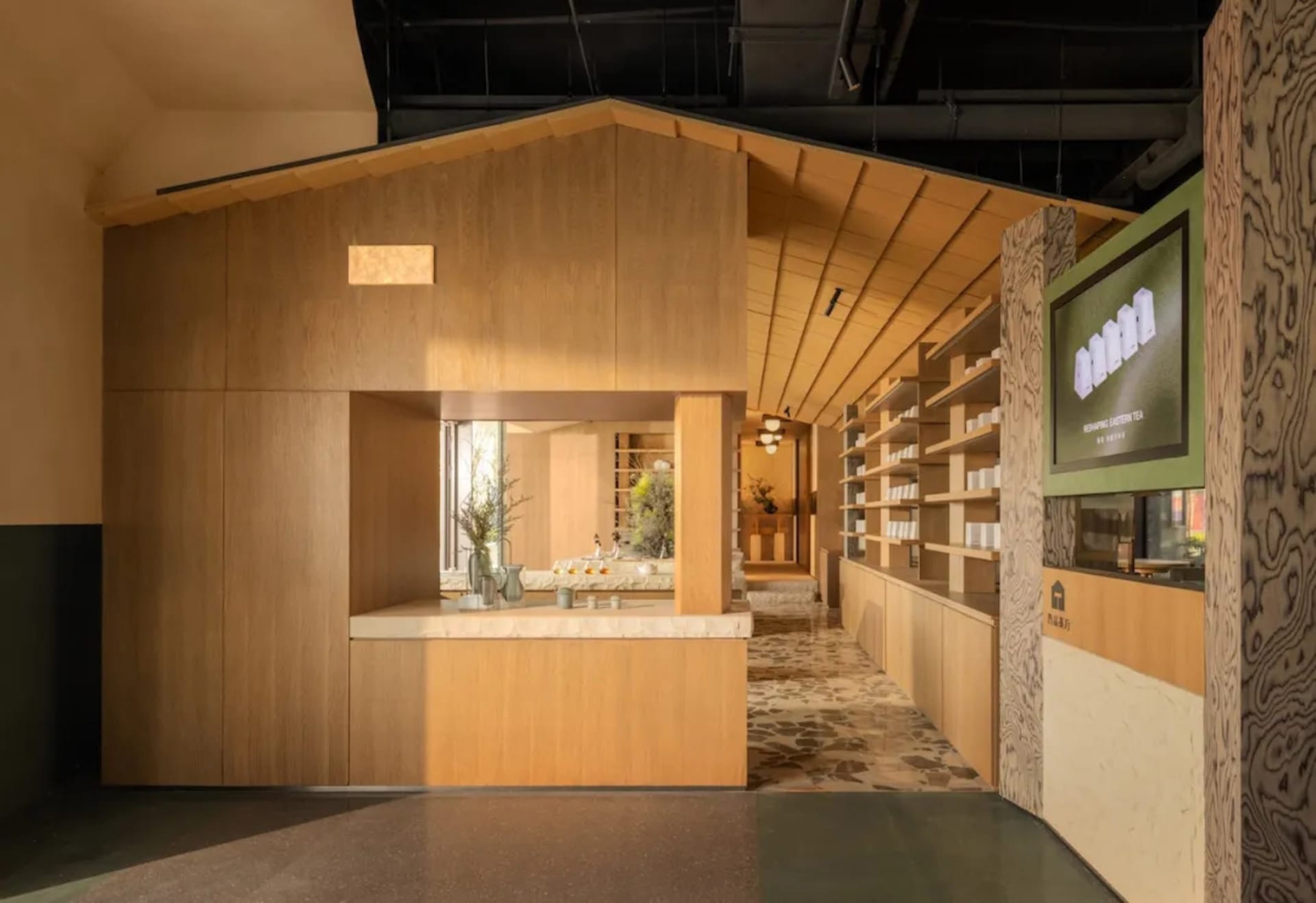 Cozy restaurant space with wooden walls and floors, featuring wine glasses and bottles on a wooden counter, with soft and inviting lighting