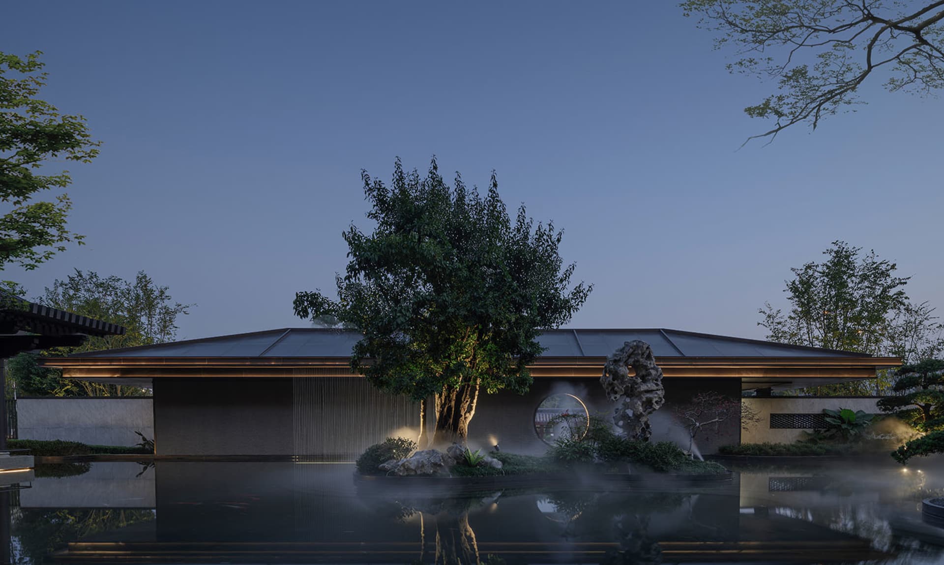 A serene modern house with a pool and a rock garden, surrounded by a large tree, with a blue pool and natural evening lighting