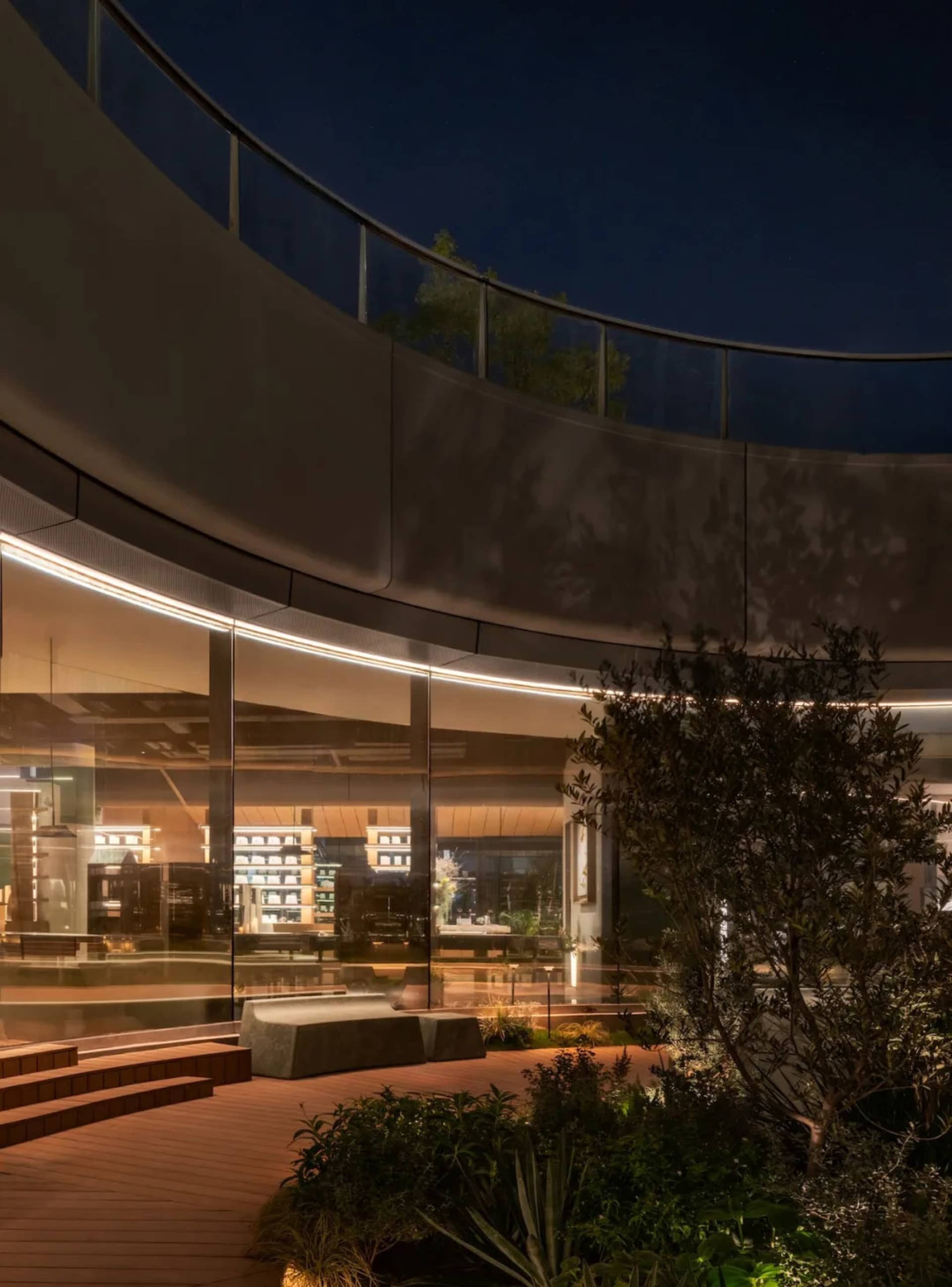A circular lobby with benches and chairs, natural light streaming in through a large window
