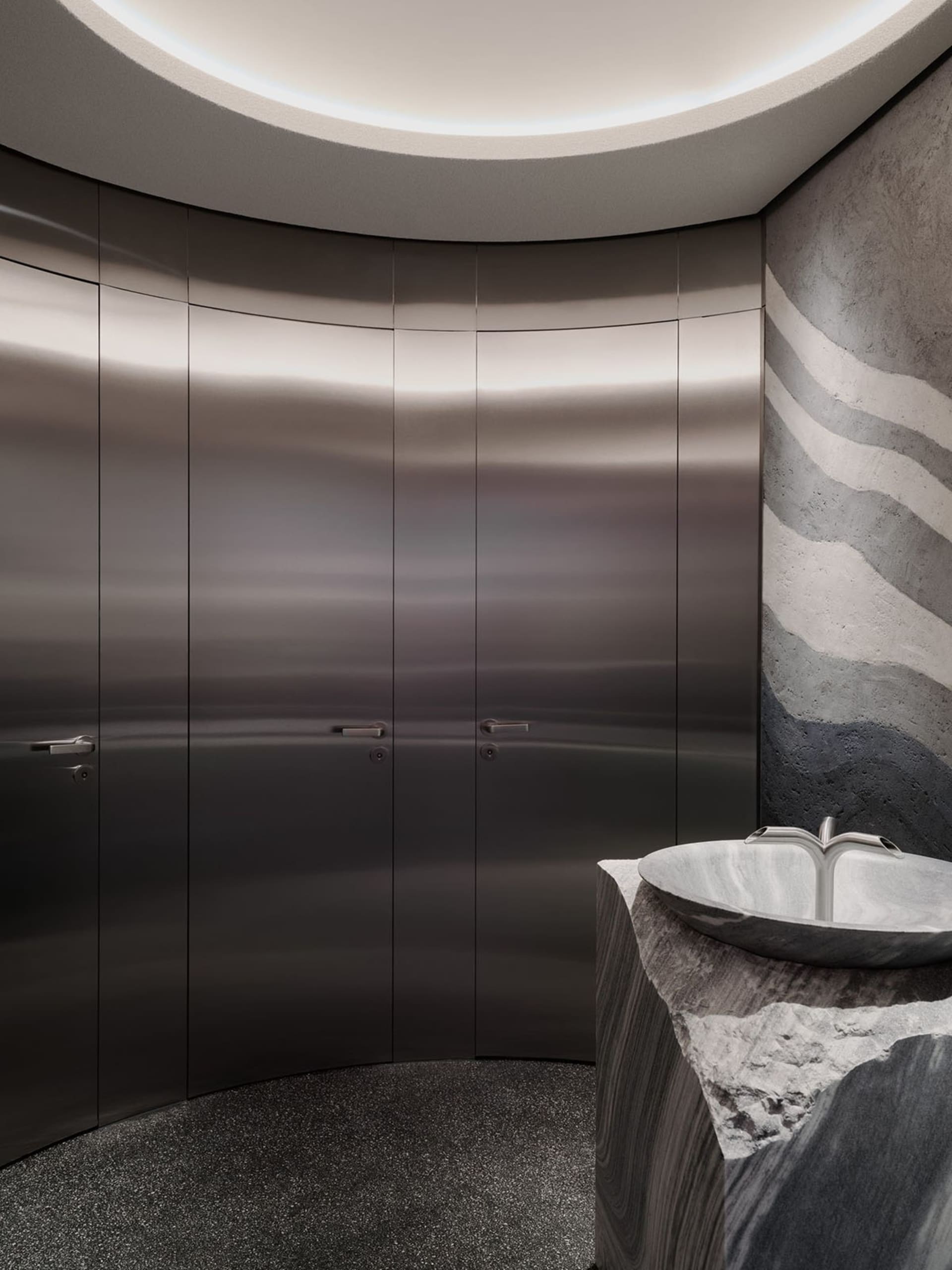 Modern bathroom with a silver sink and shower, well-lit and inviting