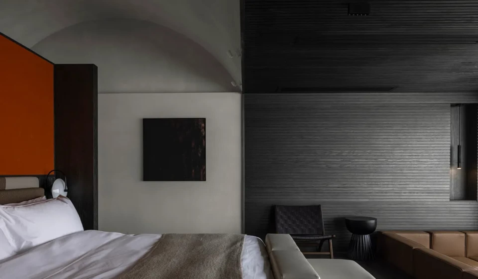 Cozy modern bedroom with a black and white color scheme, wood furniture, and dim lighting