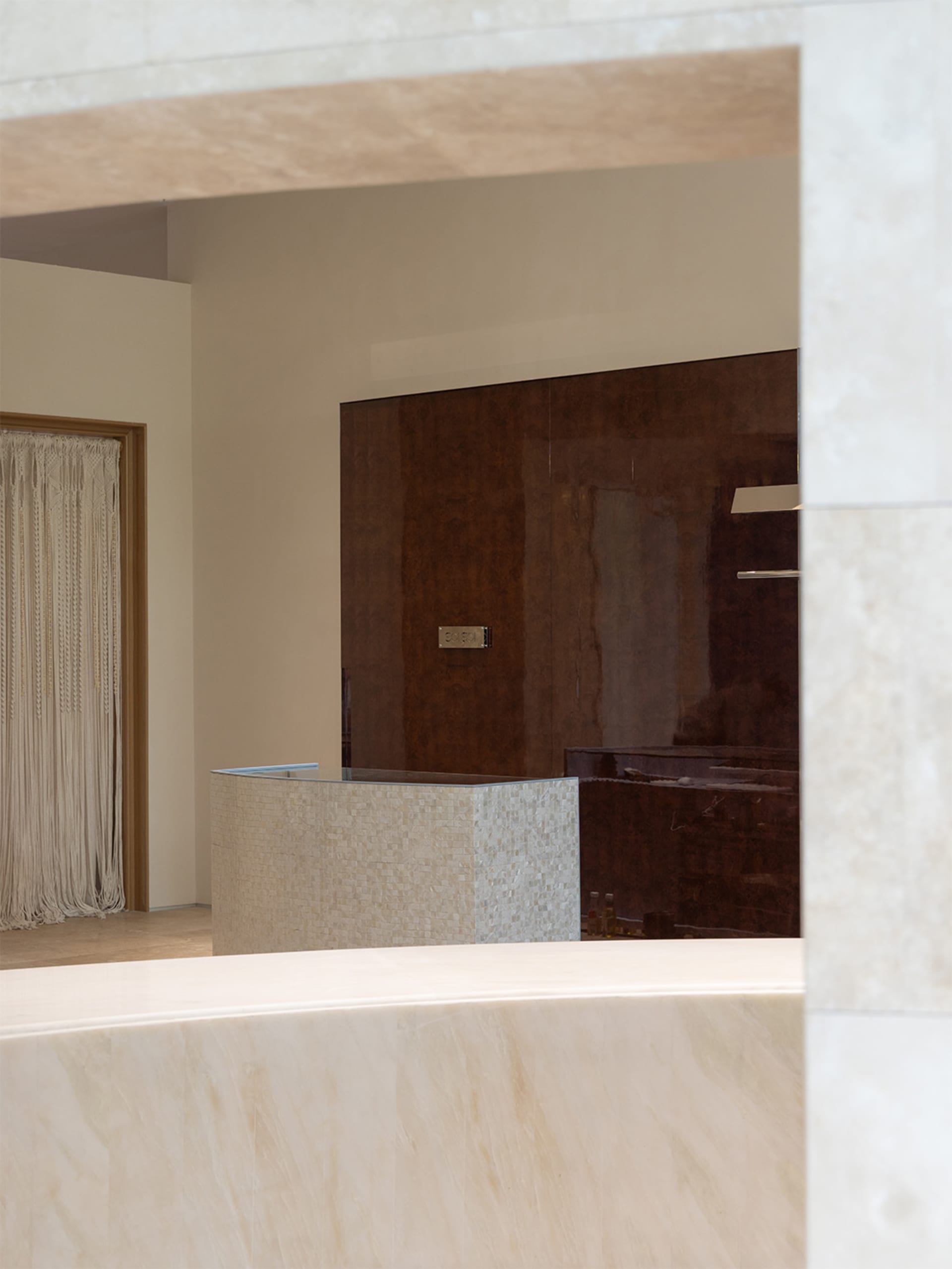 Bathroom with a marble countertop, sink, and mirror in a well-lit space