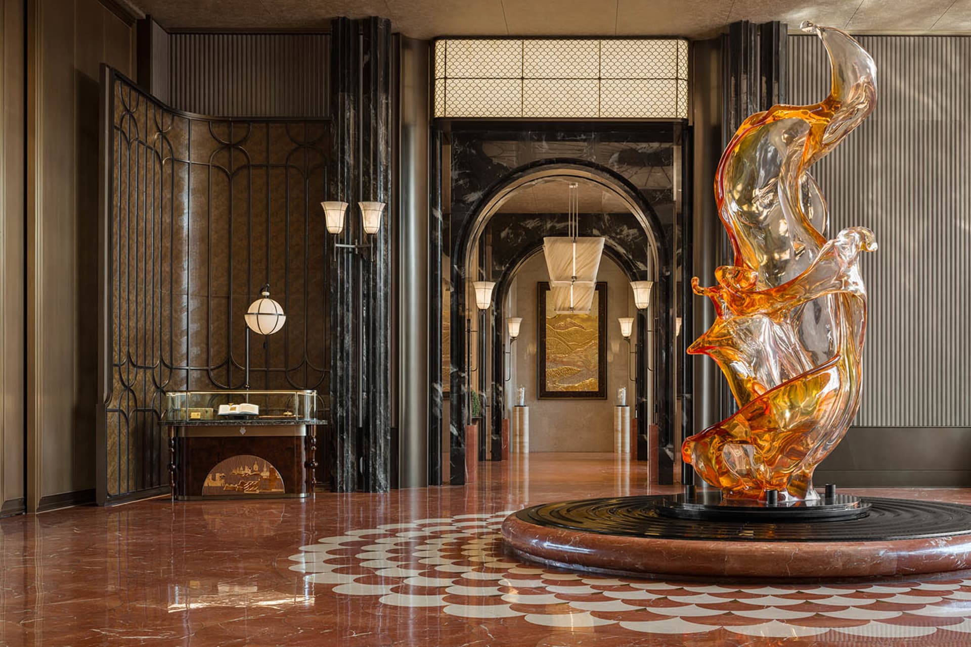 Large modern building lobby with a glass sculpture of a number two, black and white color scheme, and natural light from windows