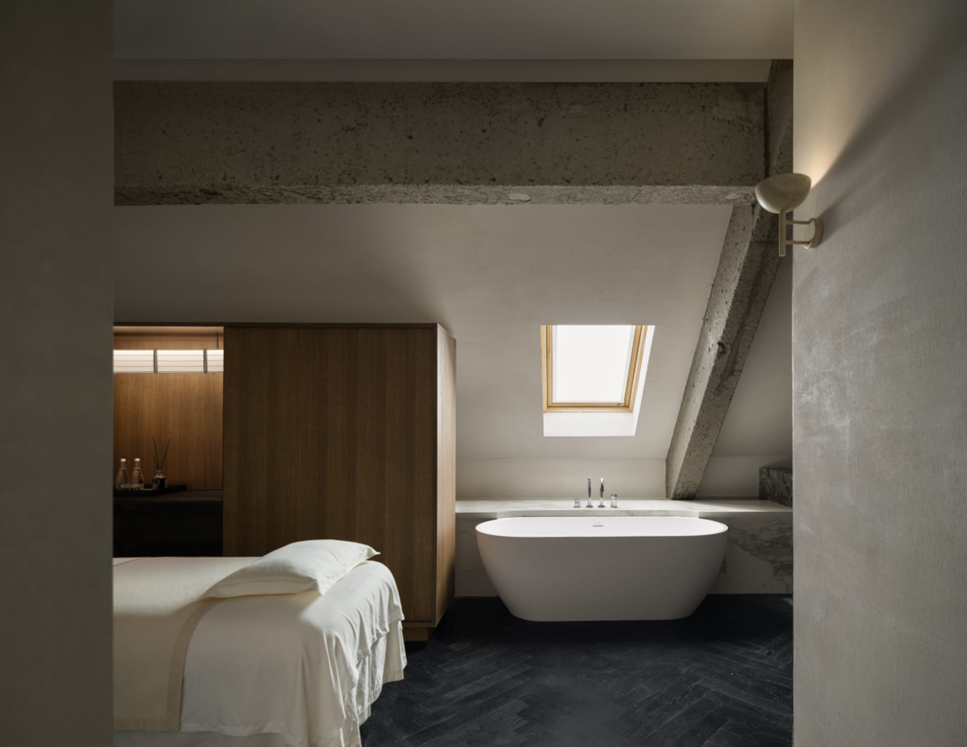 Bright and airy bedroom with a white color scheme, a bed near the window, and a bathtub in the corner