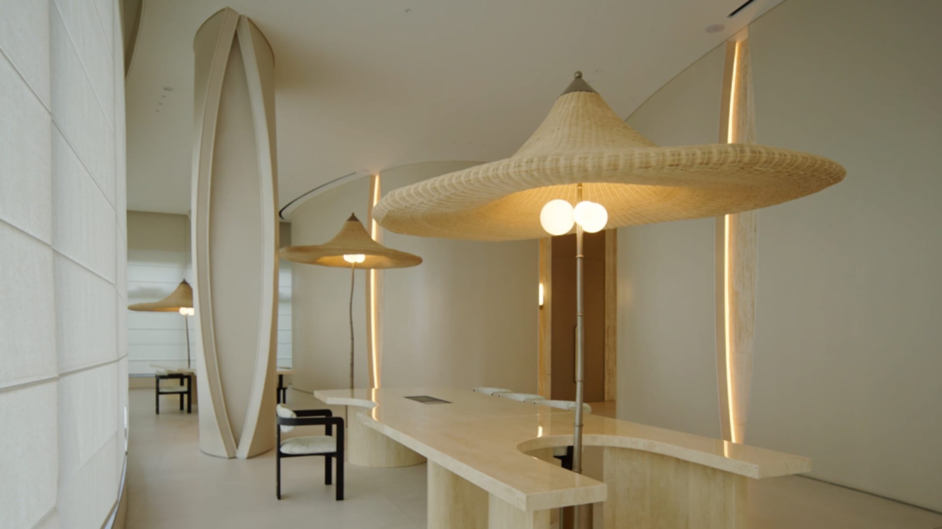 A dimly lit restaurant with a marble countertop and two chairs, creating a cozy atmosphere