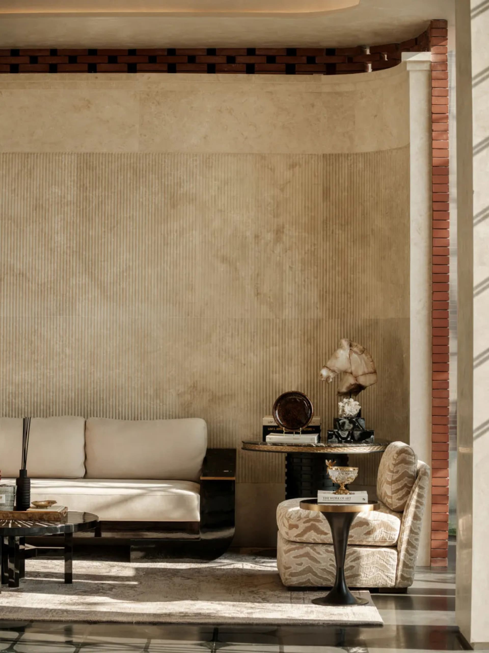 Comfortable living space with beige color scheme, modern furniture, and natural light from a window