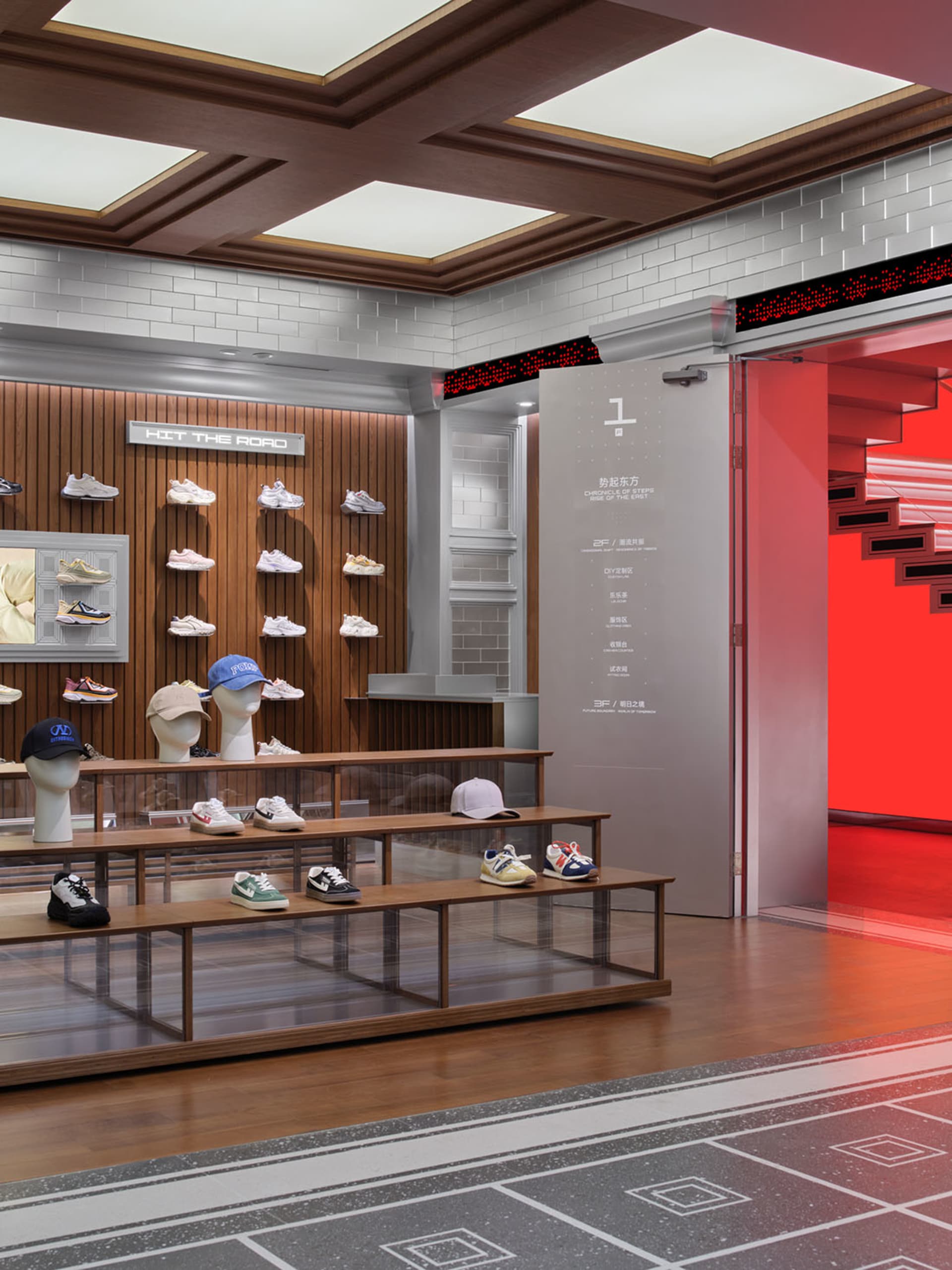 A modern shoe store with a red and white color scheme, brick walls, and a visually appealing display of shoes on shelves