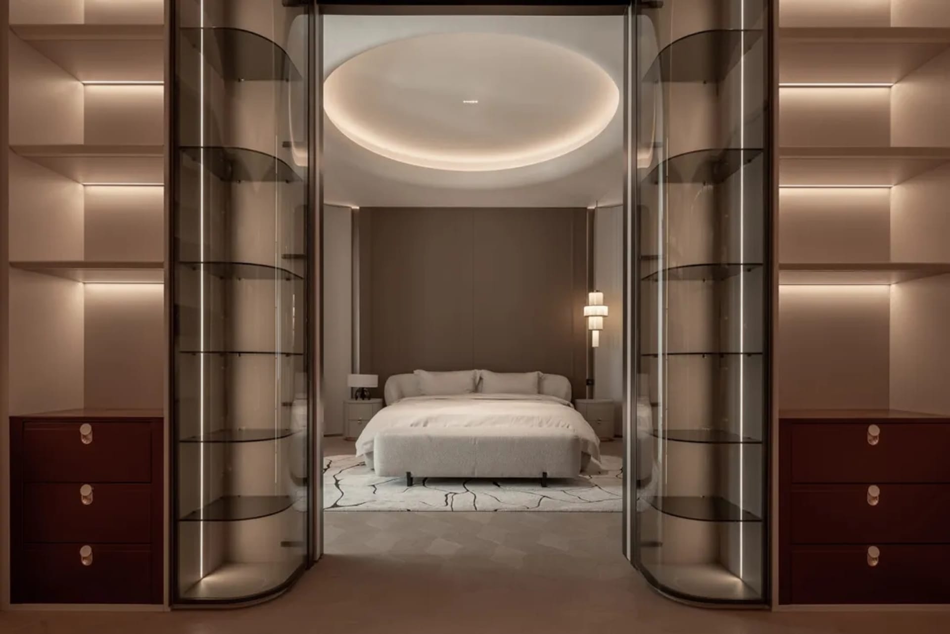 Cozy bedroom with a bed, couch, and chair, featuring a large window, wood, and glass, with soft and warm lighting