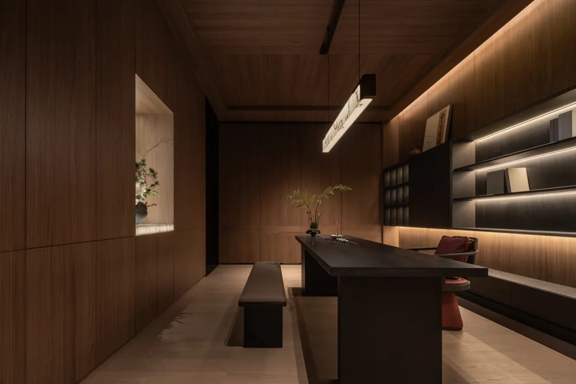 A modern kitchen and dining area with wooden floors and walls, featuring a dining table, chairs, and potted plants, creating a warm and inviting atmosphere