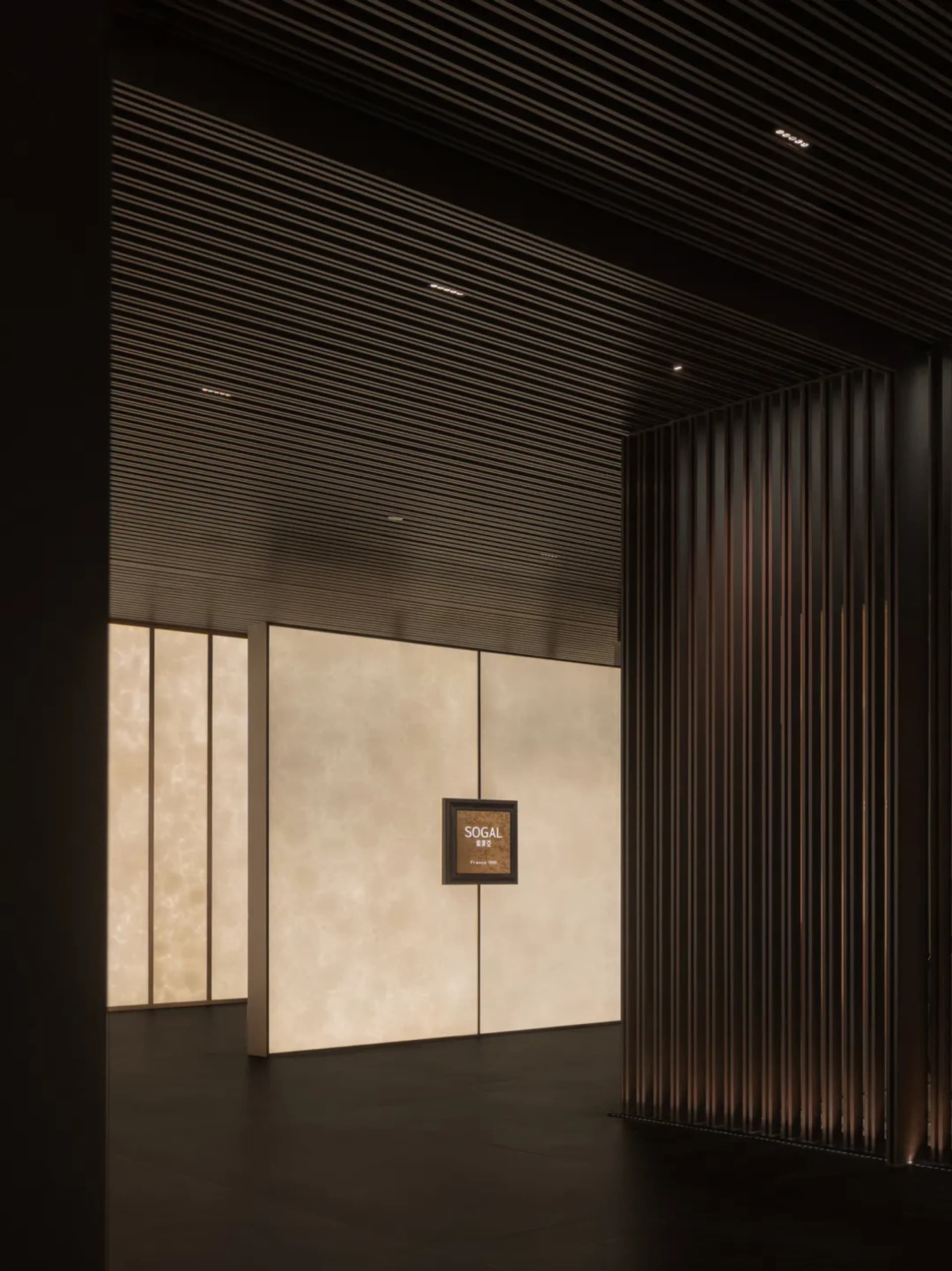 A dimly lit hallway with wooden walls and paneling, creating a sense of elegance and timelessness