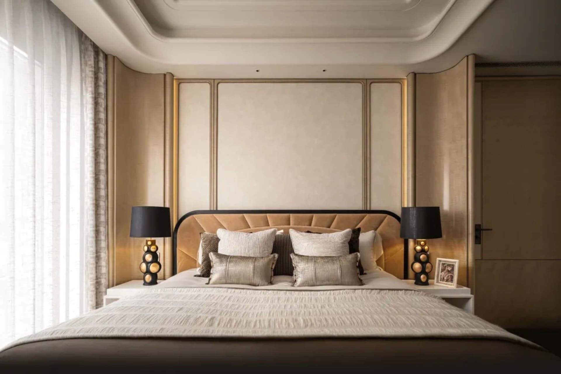 A well-lit bedroom with a bed, nightstands, and lamps, featuring a white comforter and wood and metal materials