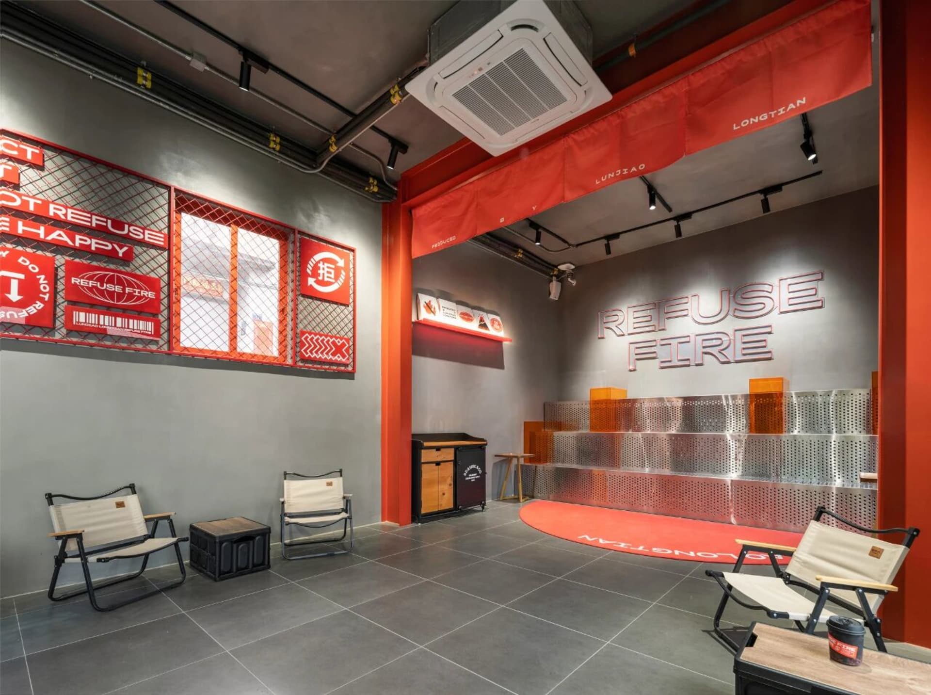 Modern dining room with a red floor, white ceiling, and dim lighting, featuring a dining table and chairs, a refrigerator, and a sink