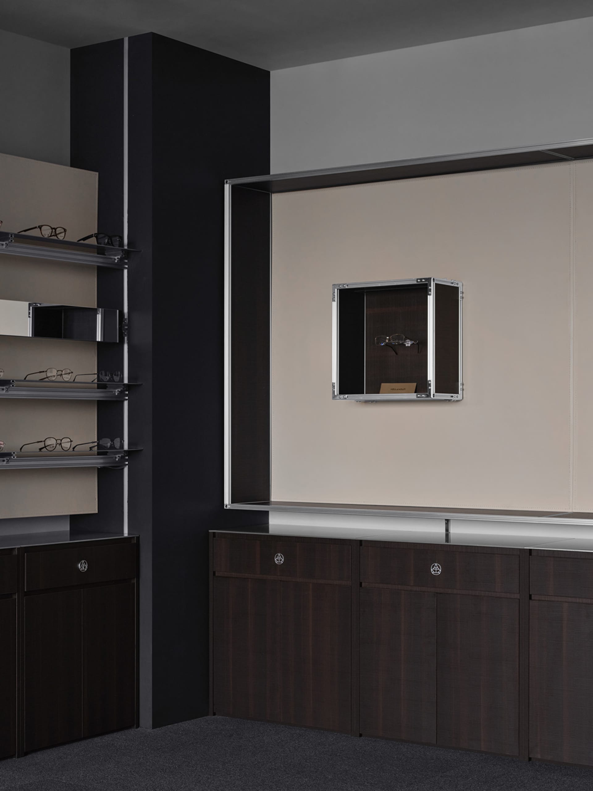 A clean and organized bathroom with a brown wooden cabinet and mirror, featuring various pairs of glasses arranged neatly on the cabinet