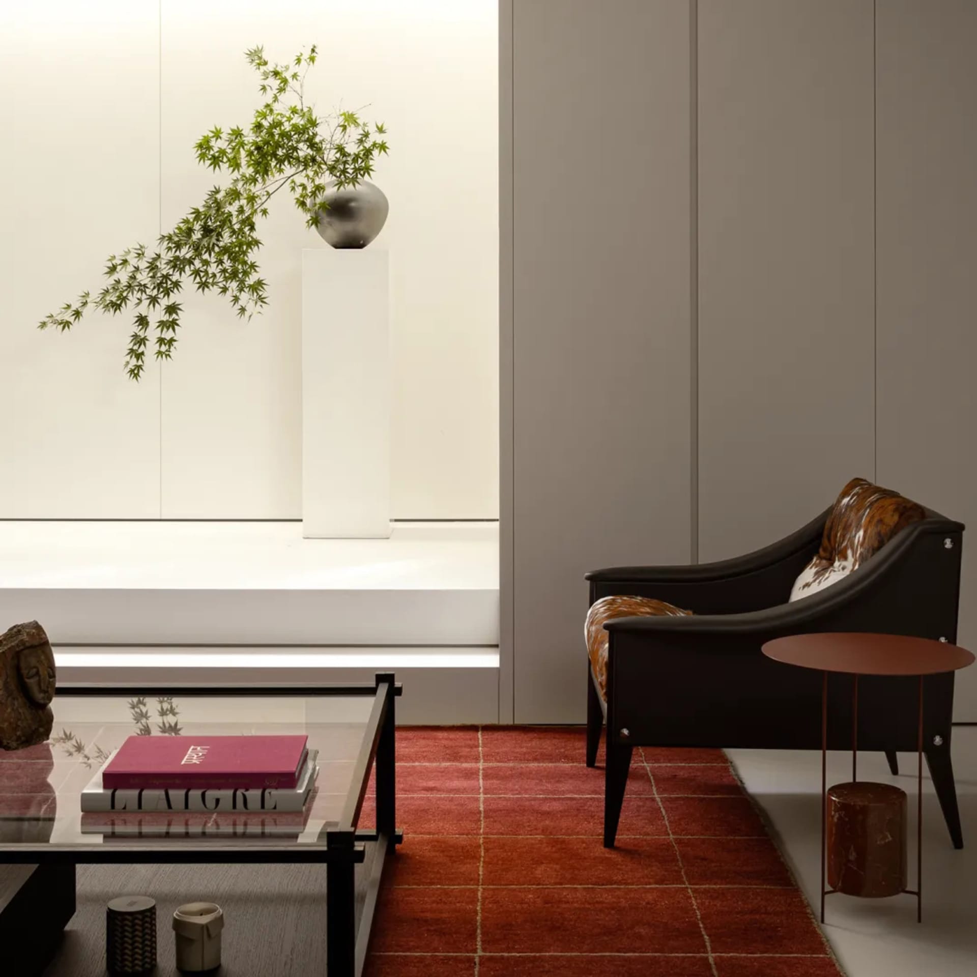 A modern living room with a red carpet, a black chair, a dining table, and a potted plant, set in a well-lit space with a warm and inviting atmosphere