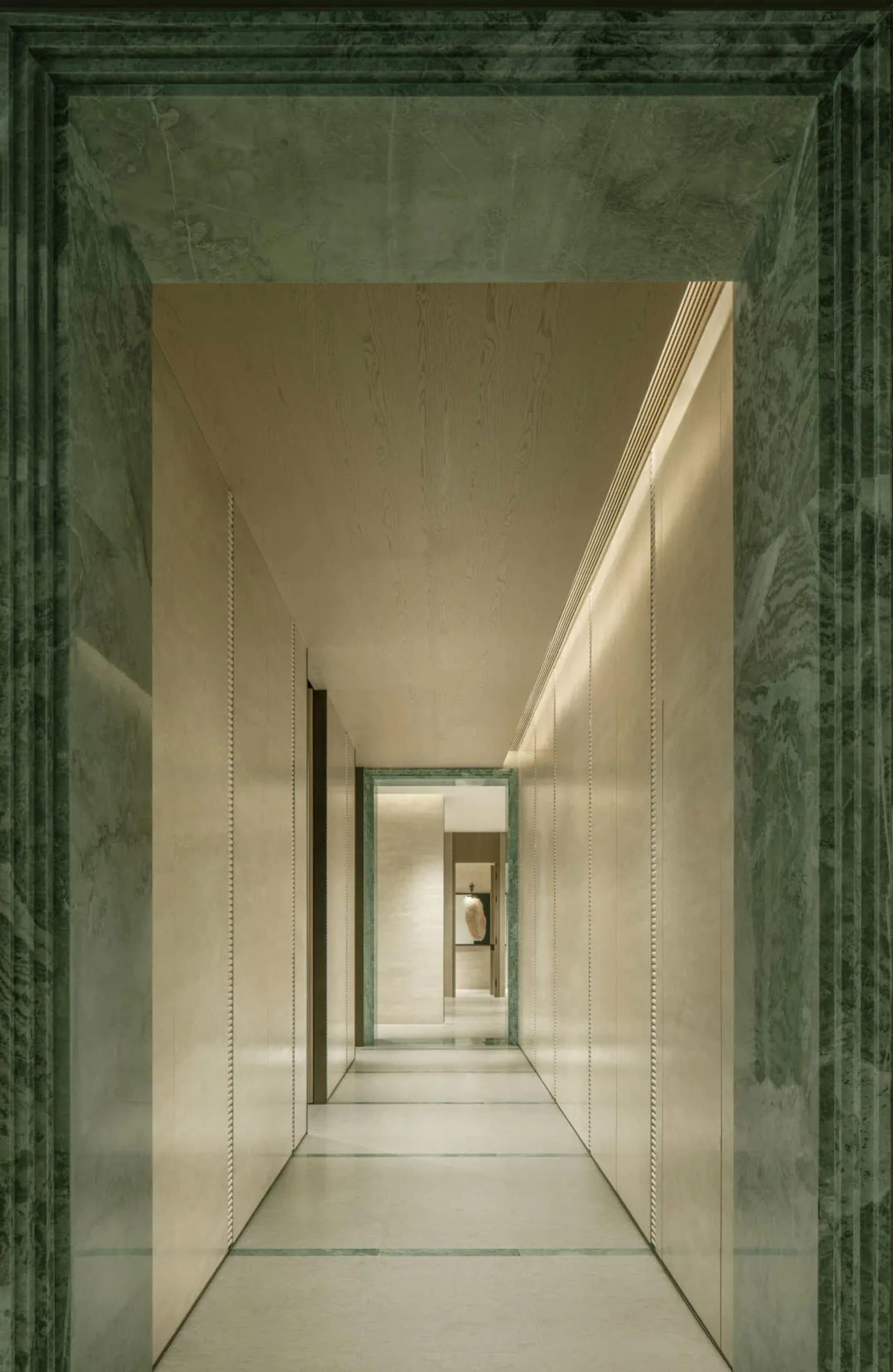 A dimly lit hallway with white walls and a wooden floor, featuring a doorway at the end