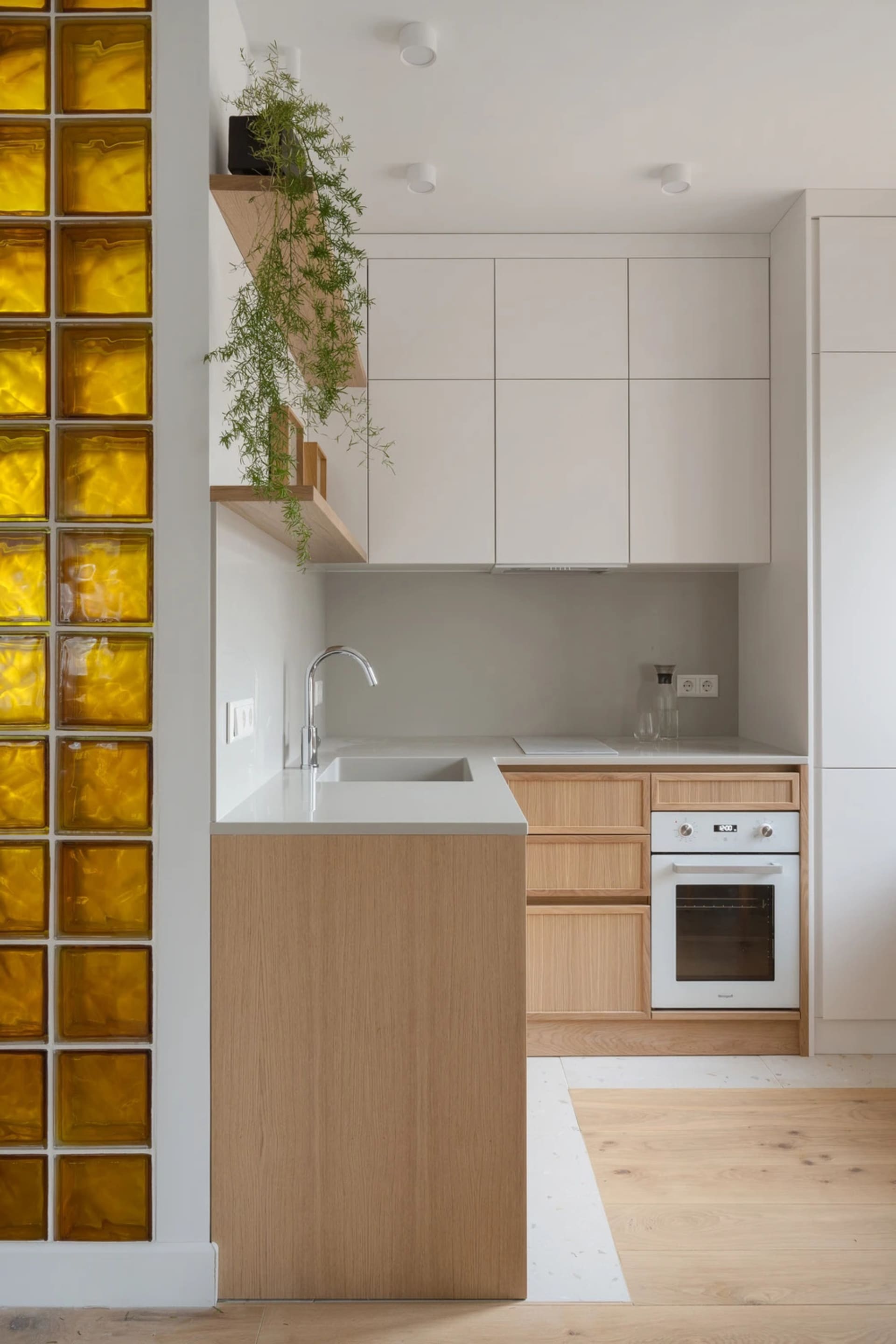 A bright and inviting kitchen and dining room with a predominantly white space, wooden elements, and natural lighting