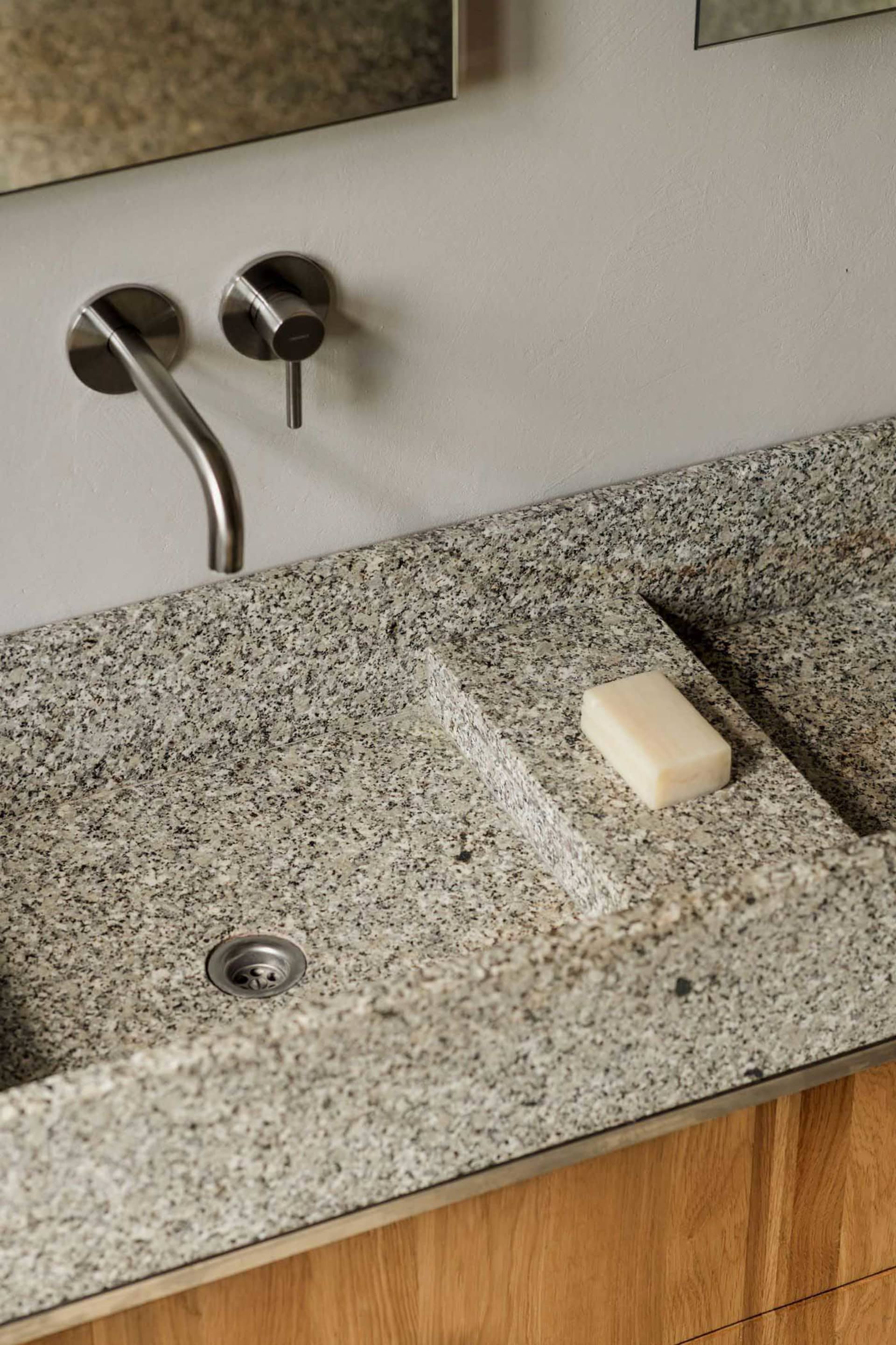 A well-maintained bathroom with a marble sink and a soap dish on the counter