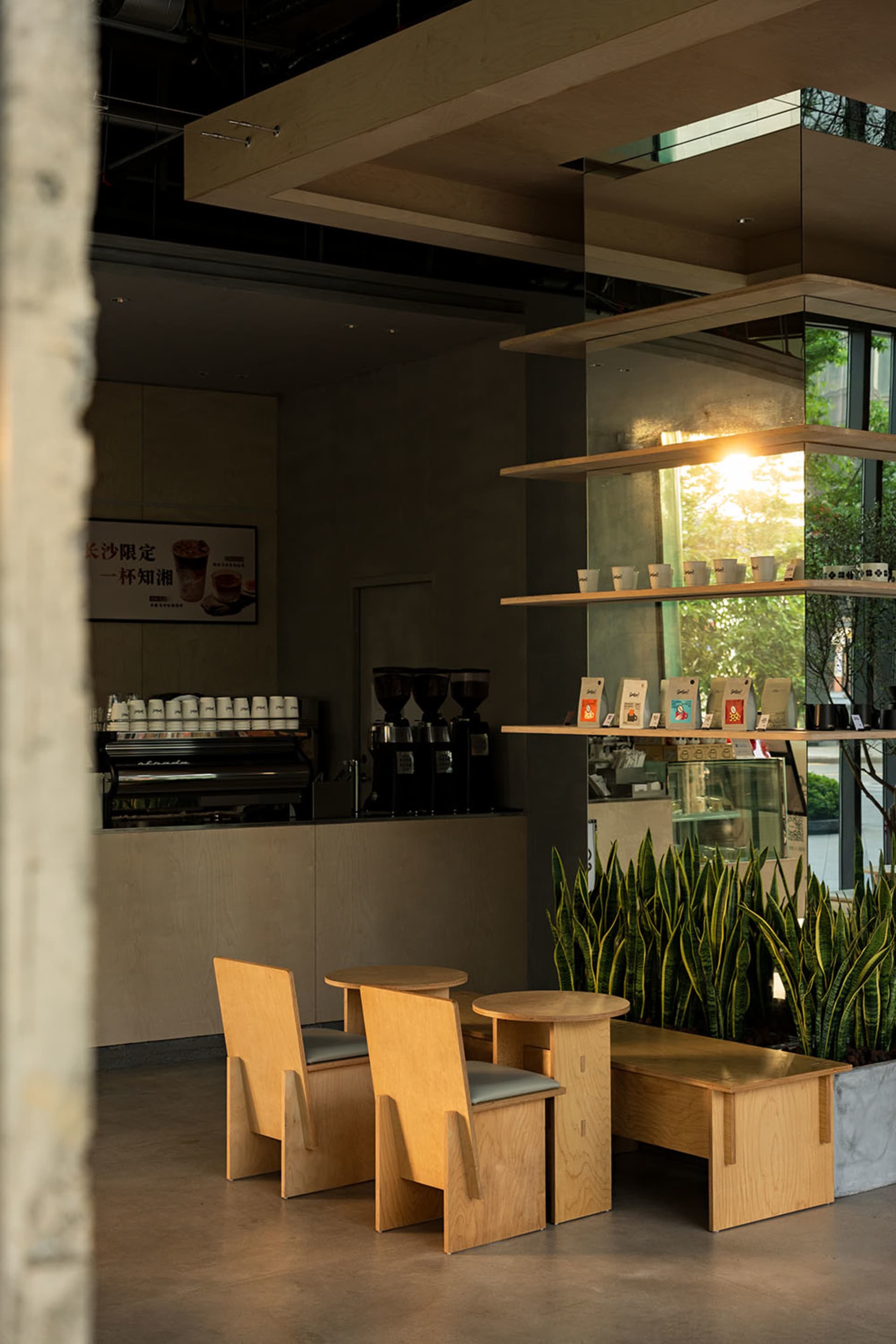A well-lit coffee shop with a variety of seating options, natural light, and modern design elements