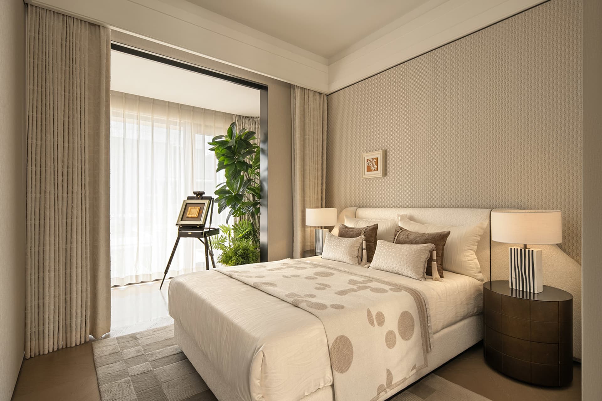 Cozy bedroom with a white bed, a potted plant, and a picture on the wall, set against a white color scheme