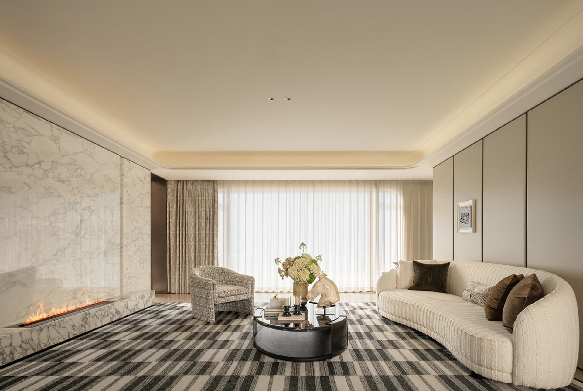 A modern living room with a couch, chair, and coffee table, featuring a large window and white furniture, with natural light filling the space