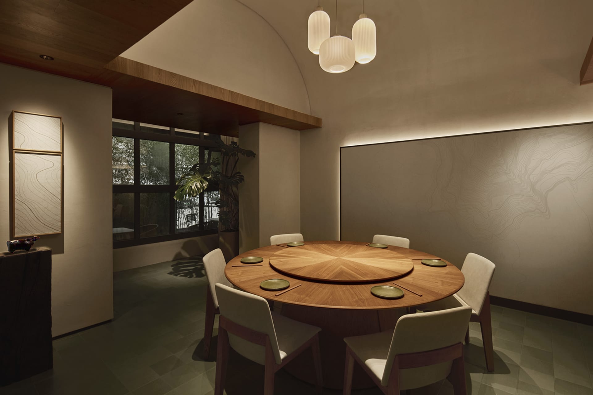 Modern minimalist dining room with a large round oak table, six upholstered chairs, curved wooden ceiling detail, and textured wall with topographic lines.