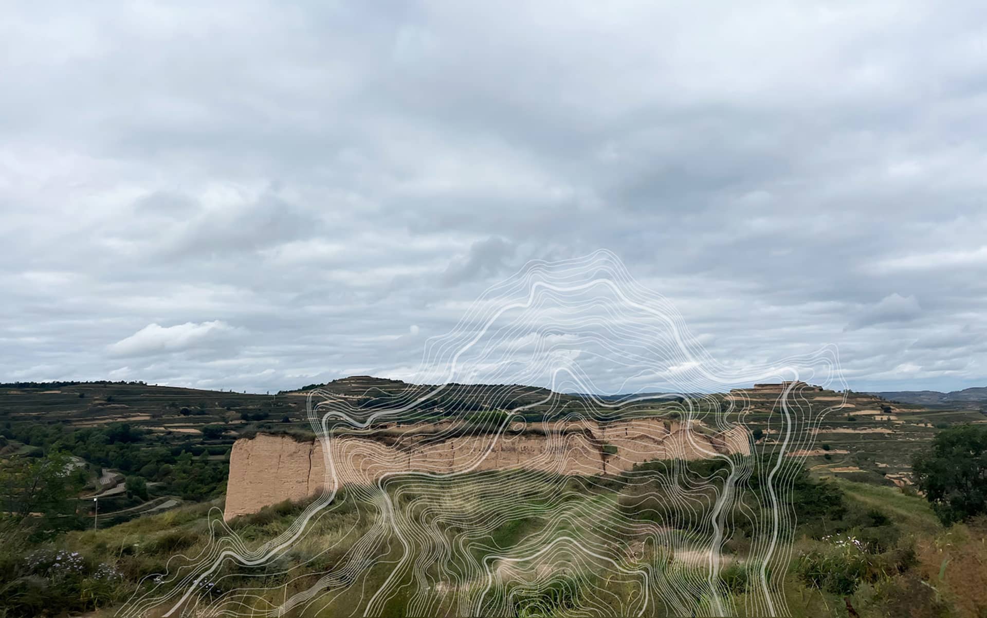 Wide landscape view of the Loess Plateau in China featuring eroded earthen hills, green vegetation, and a large white abstract topographic wave graphic overlay under a cloudy sky.