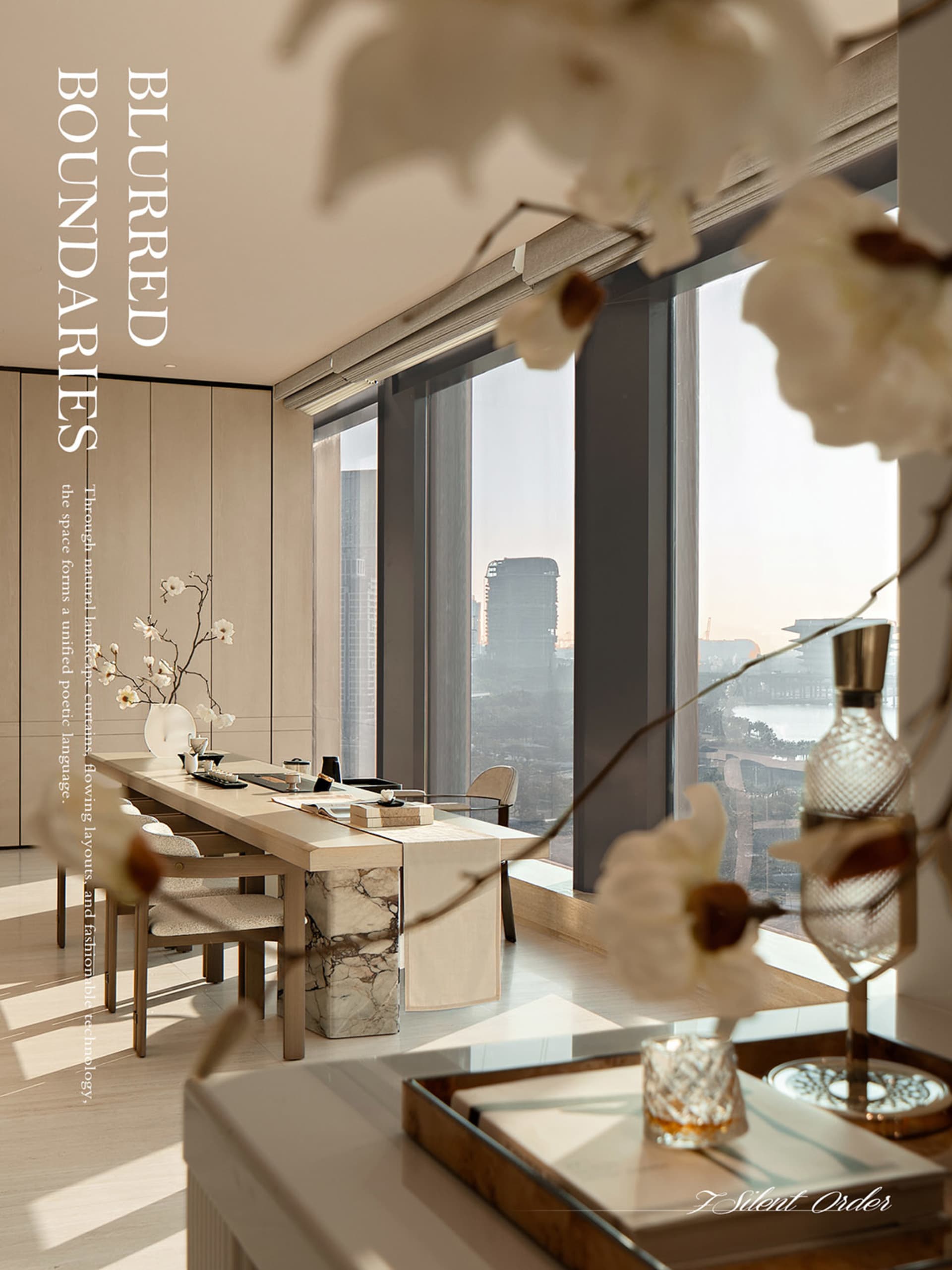 Modern minimalist dining room featuring a long light-wood and marble dining table, upholstered chairs, large floor-to-ceiling windows with city skyline view, and elegant white floral arrangements.