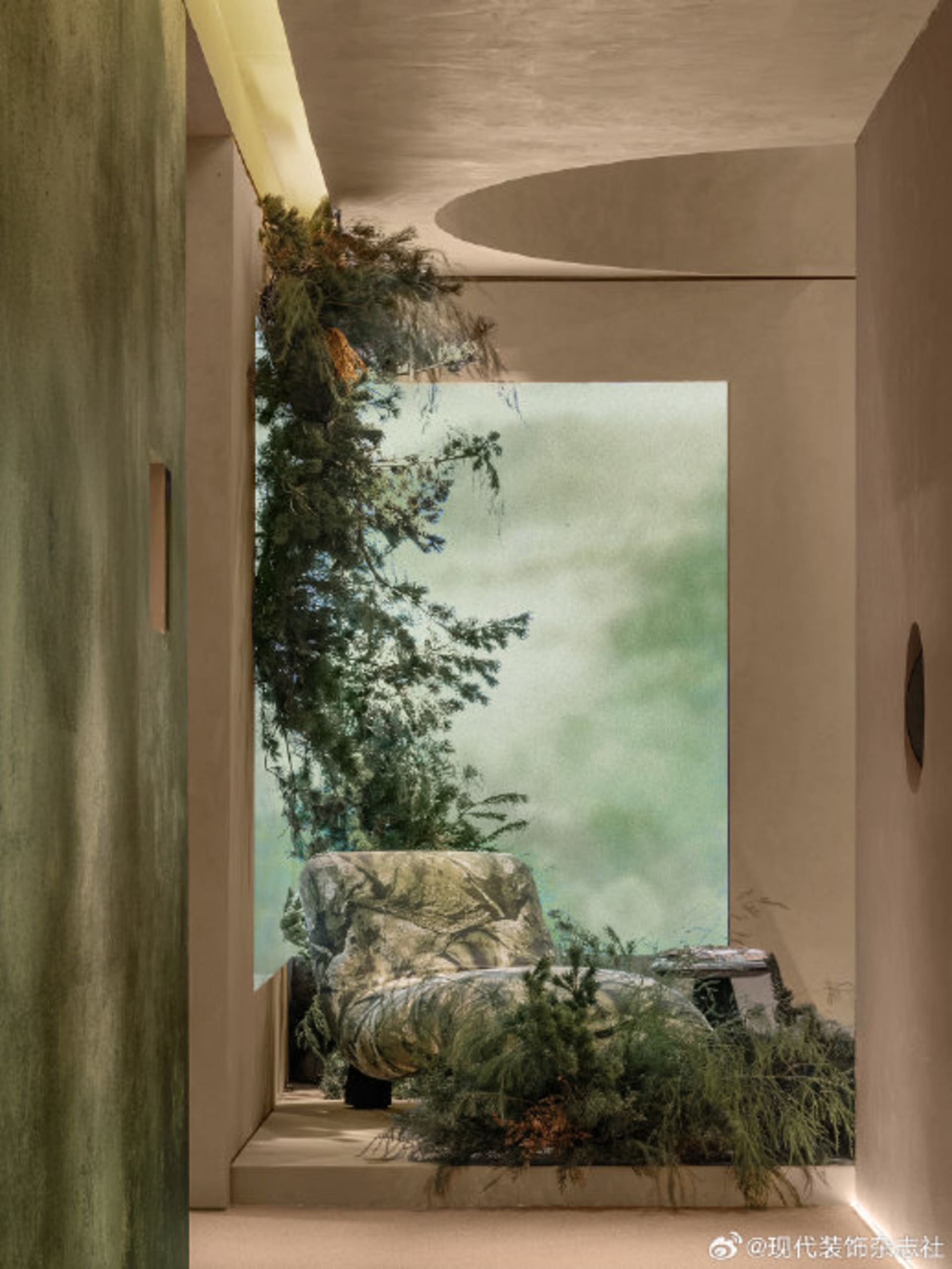 Modern minimalist living space featuring a sunken lounge chair surrounded by lush indoor plants, textured green plaster walls, and a large nature mural creating an indoor forest effect.