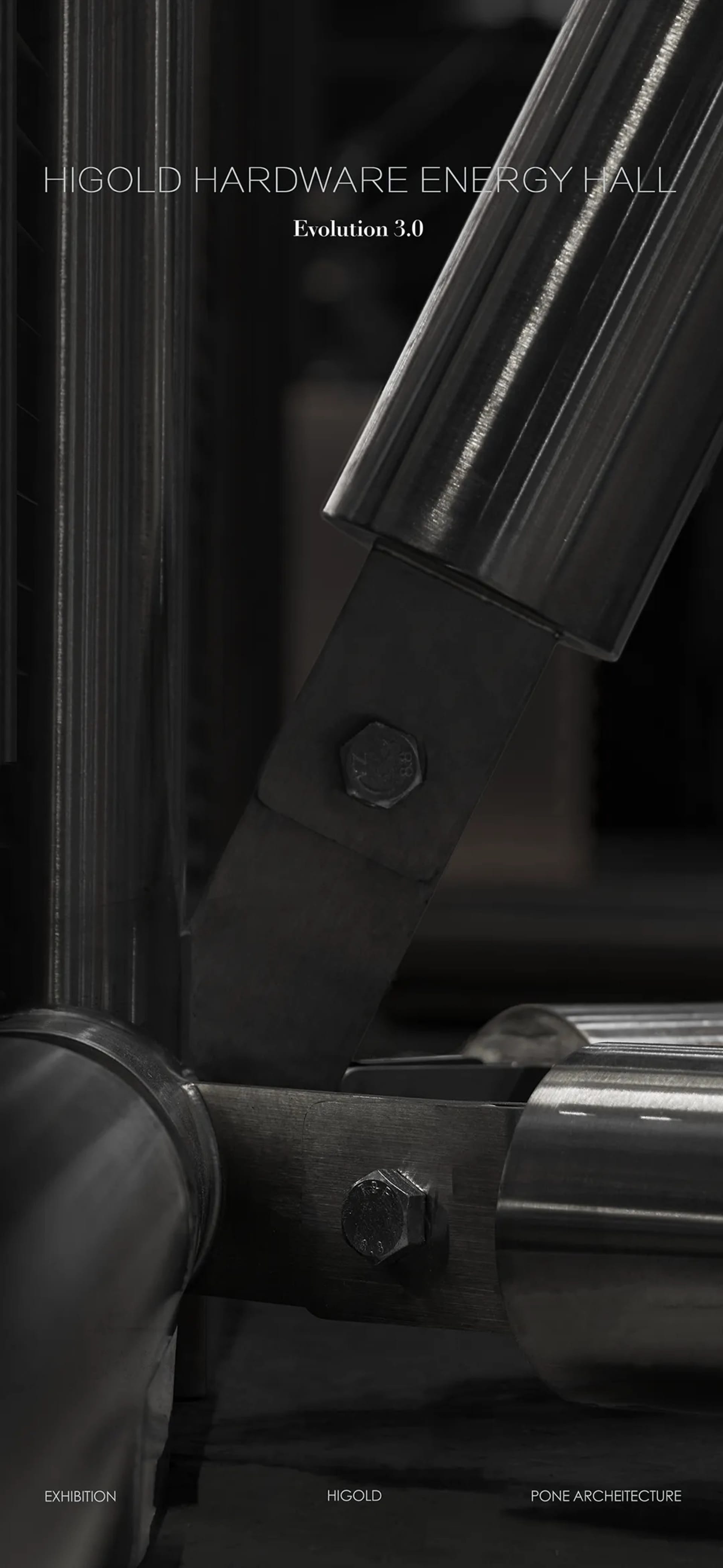 Close-up of a dark metallic industrial pivot joint with visible bolts and brushed steel surfaces, part of the Higold Hardware Energy Hall exhibition.