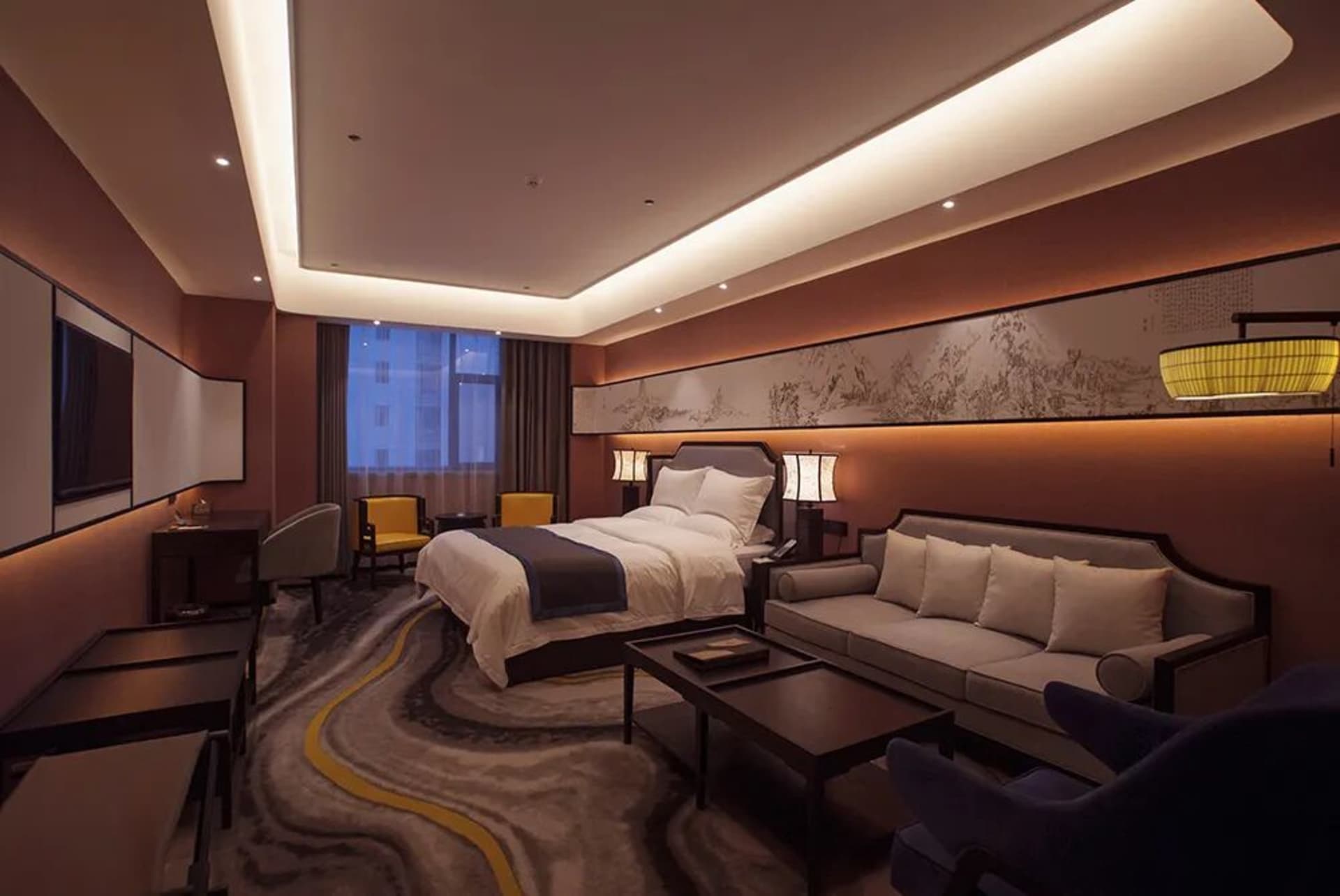 Modern luxury hotel bedroom featuring a large Chinese ink landscape painting, marble-patterned area rug, walnut furniture, and warm ambient lighting.