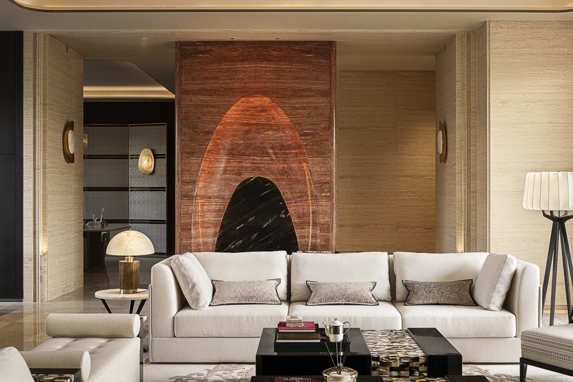Modern luxury living room featuring a large white sectional sofa, black marble coffee table, and a dramatic two-tone marble feature wall with an arched cutout in warm brown and black onyx.