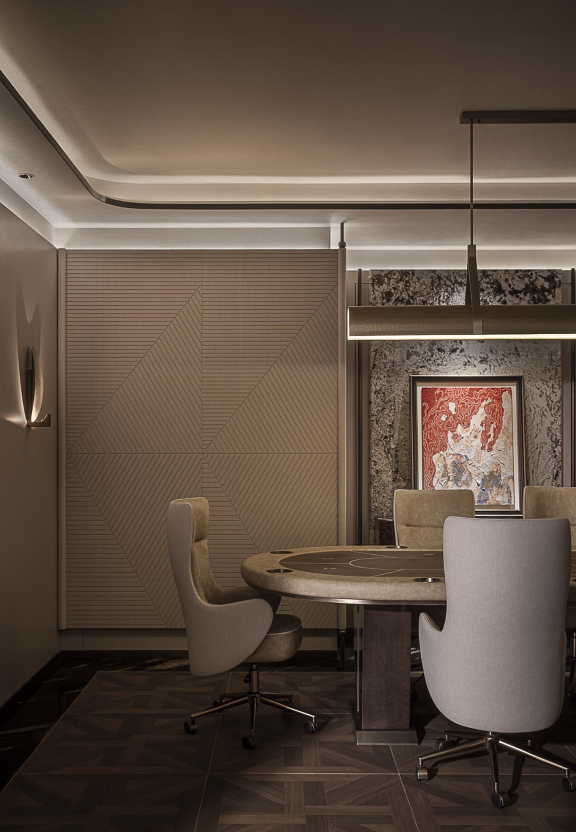 Modern luxury private poker room featuring a round wooden table, four taupe velvet swivel chairs, geometric wood-paneled wall, marble accent wall with red abstract art, and linear pendant lighting.
