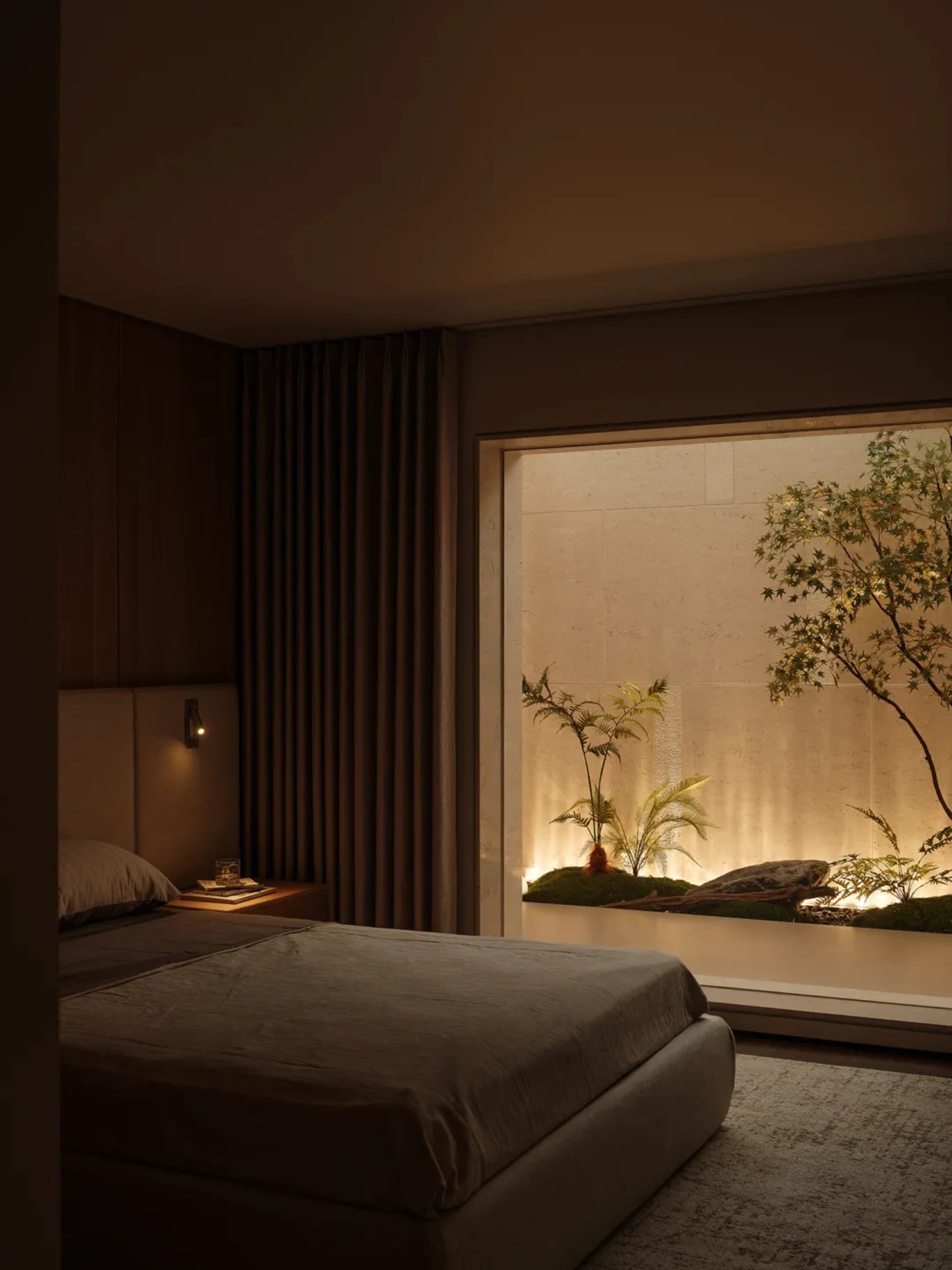 Modern minimalist bedroom featuring a large built-in illuminated indoor garden with ferns, moss, rocks and a Japanese maple tree, paired with warm wood paneling and neutral linen bedding.