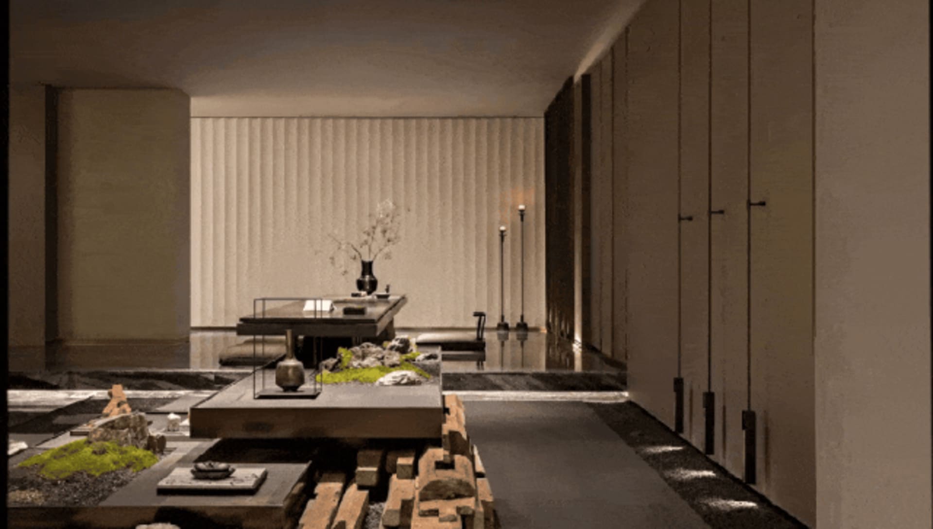 Modern Japanese zen living room featuring a large walnut wood platform, tatami-style sunken seating, vertical wood slat wall, and minimalist stone and moss arrangements.